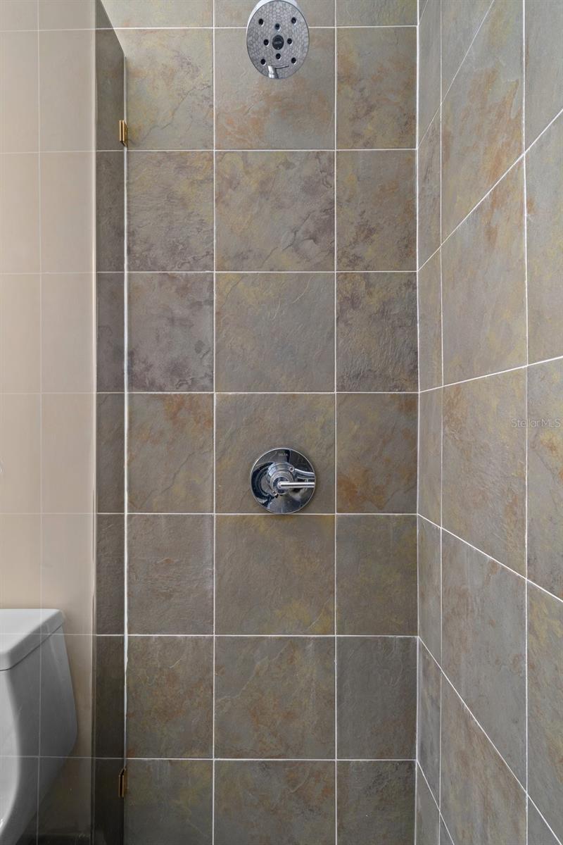 Tiled walk-in shower.