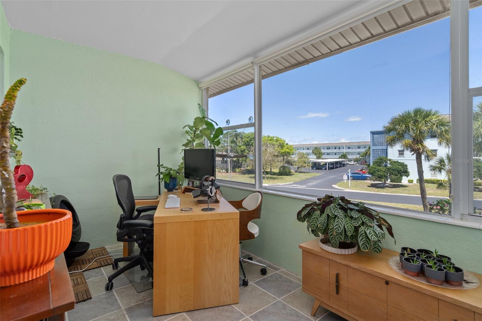 The Florida room features a large picture window and tile floor.