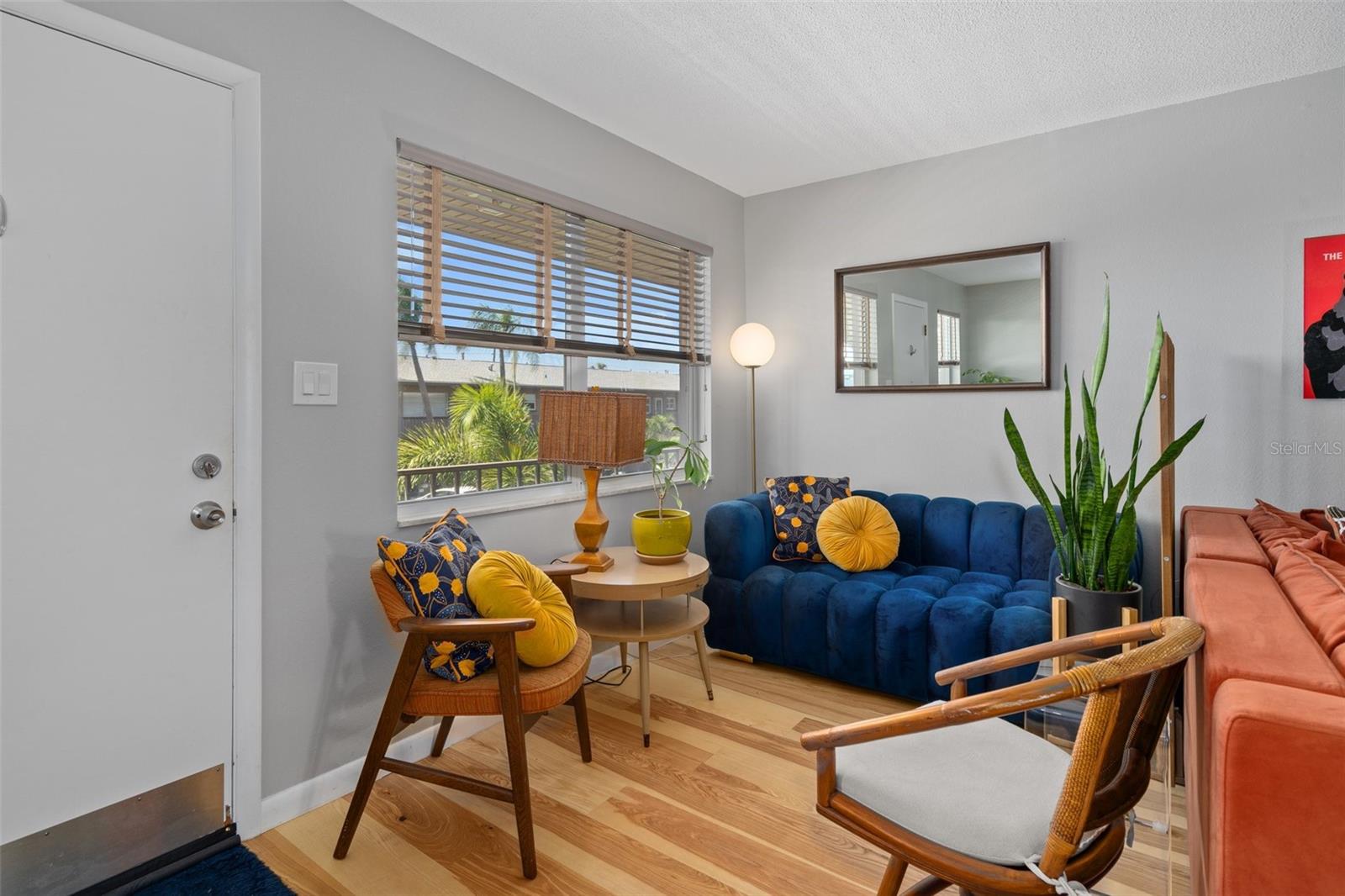 The living room features beautiful engineered hardwood floors and a neutral color palette.