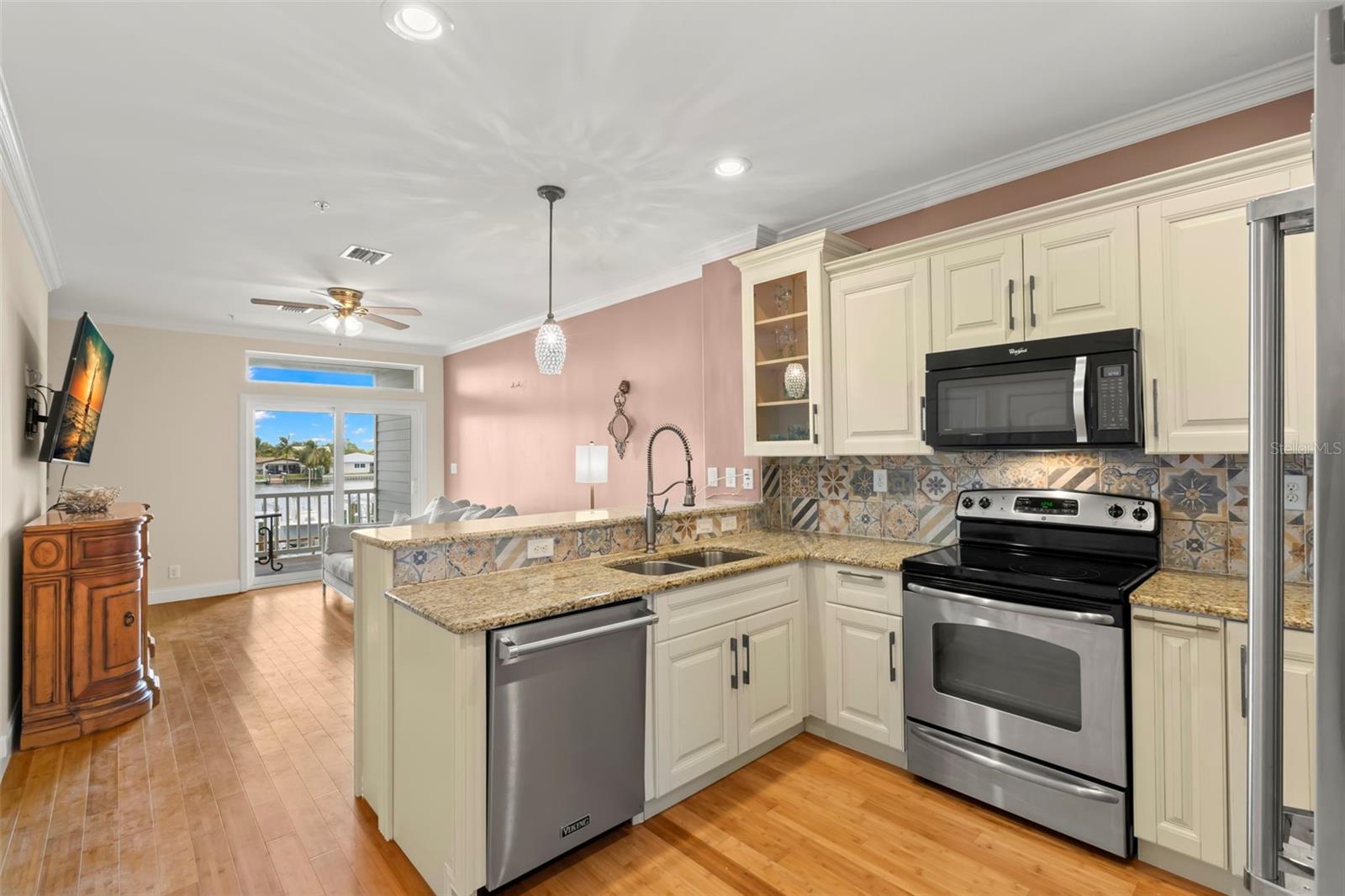 Cooking with a view! This open kitchen design keeps you connected to the living space and stunning water views, all while enjoying modern amenities and elegant finishes.