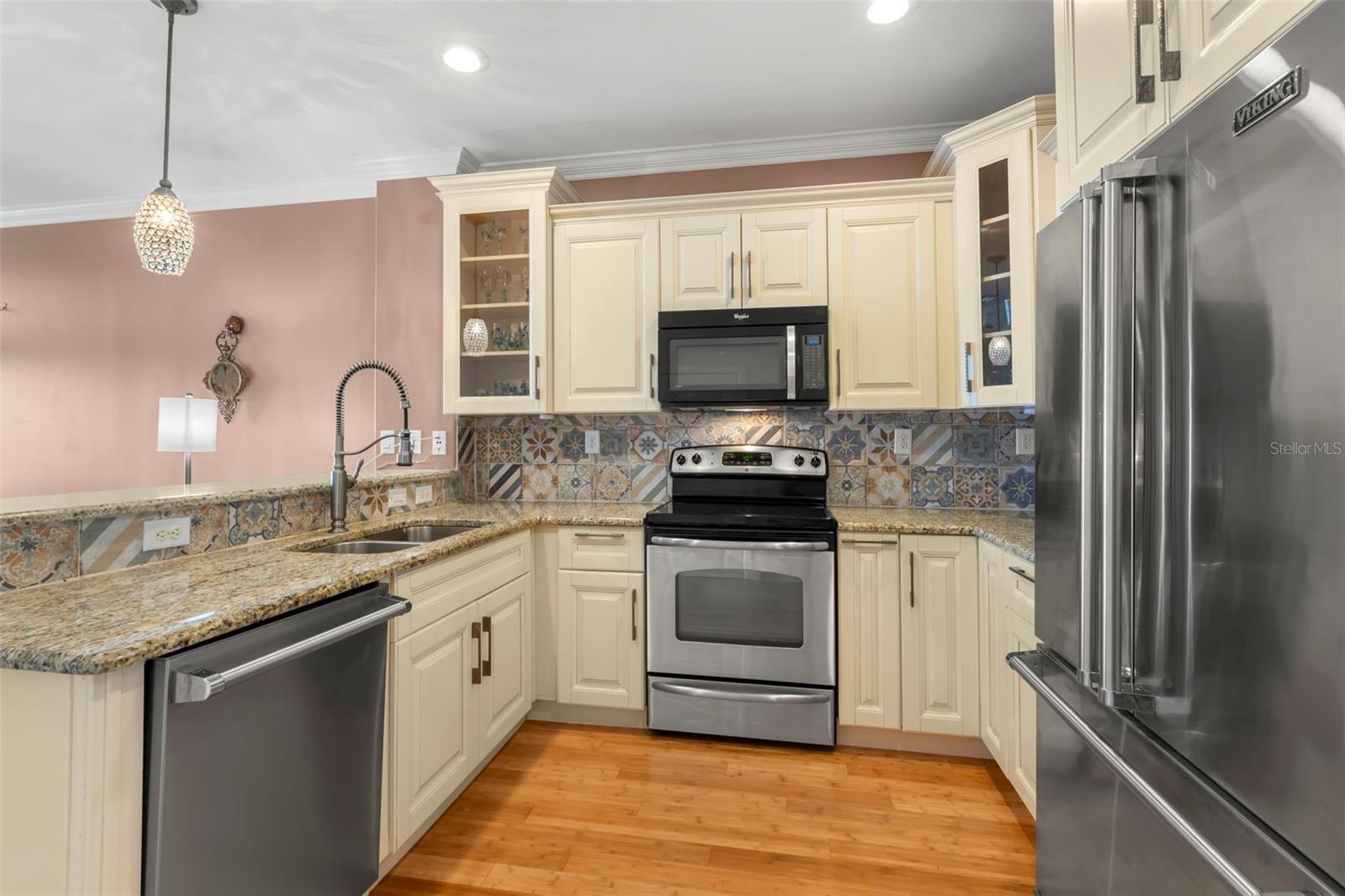 This kitchen blends style and functionality effortlessly, featuring custom tile backsplash, granite countertops, and high-end stainless steel appliances—perfect for creating culinary masterpieces.