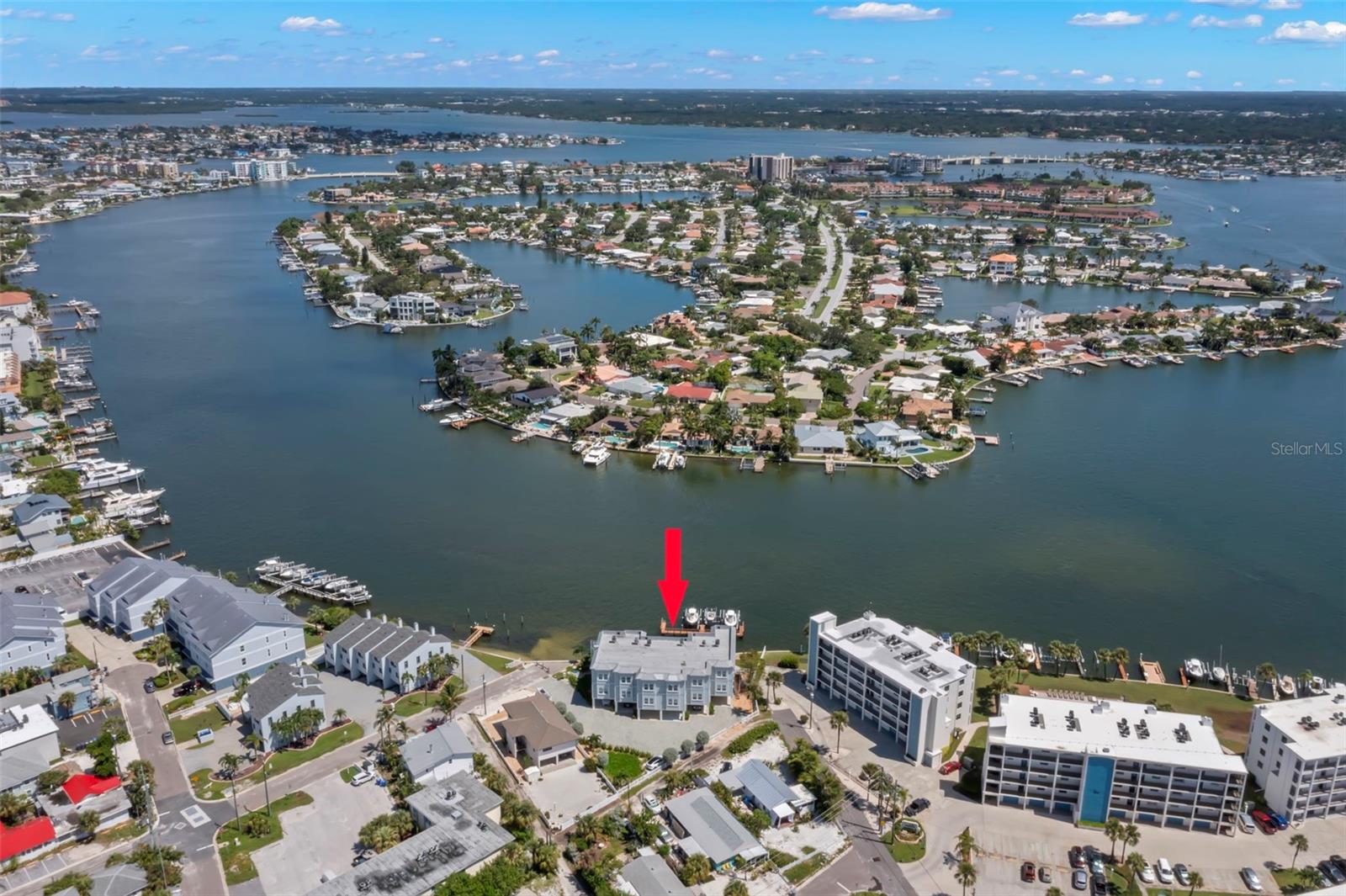 Welcome to your serene waterfront escape! This stunning aerial view showcases the townhome’s prime location along the tranquil intracoastal waterways, perfect for those seeking a blend of luxury and peaceful living.