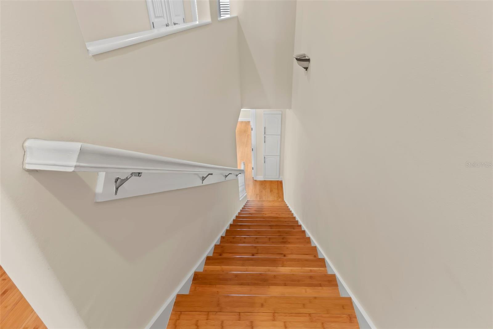 Stairway to foyer with doors to garage and exterioir front.