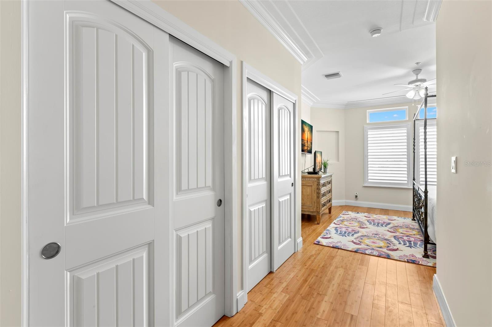 Step into the tranquil retreat of the en suite primary bedroom, where relaxation awaits just beyond these elegant double doors.