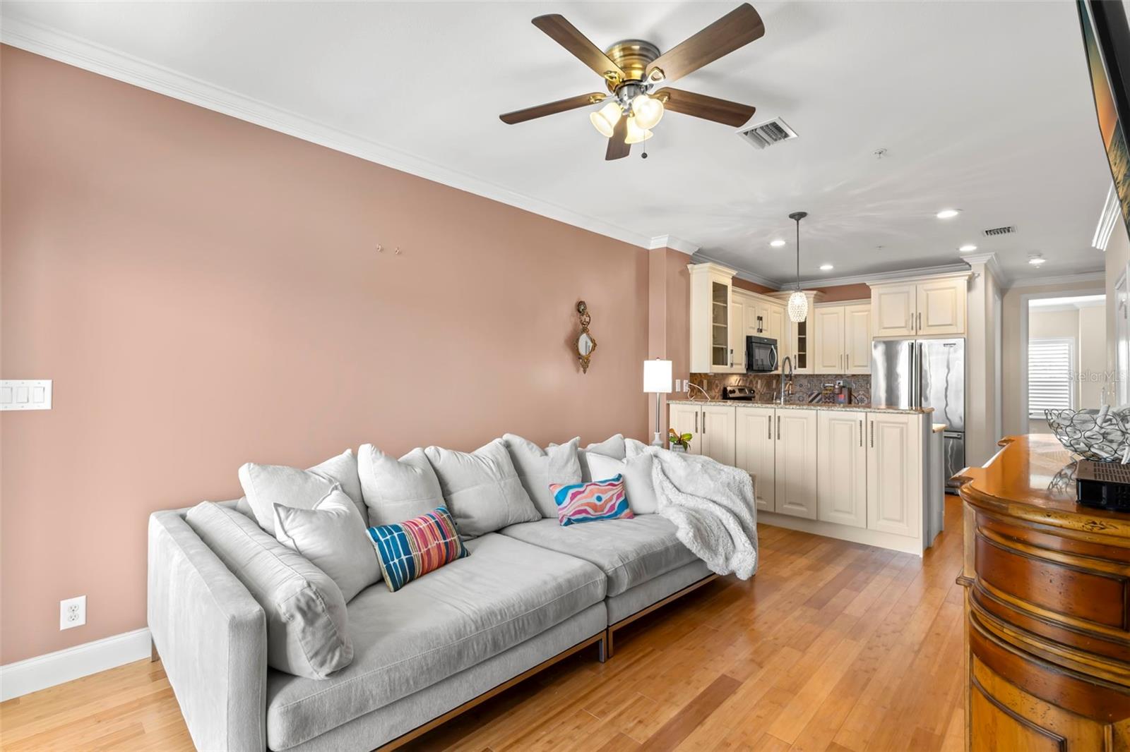 Cozy up in this inviting living area, complete with bamboo flooring and an open layout that flows effortlessly into the stylish, updated kitchen. Perfect for relaxing or entertaining!