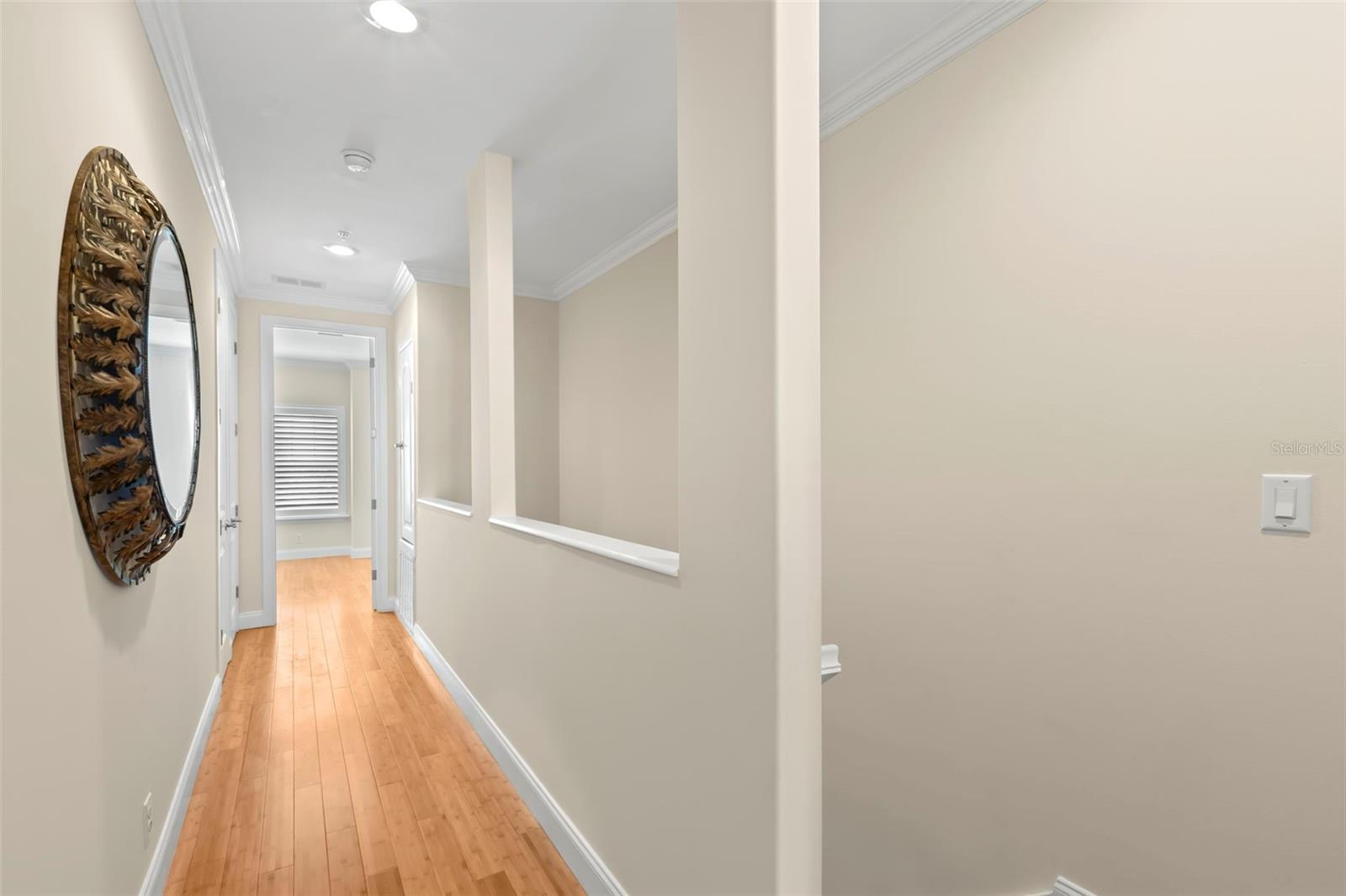 This hallway gracefully connects the primary bedroom with the guest bedroom, providing a seamless flow between spaces in the home.