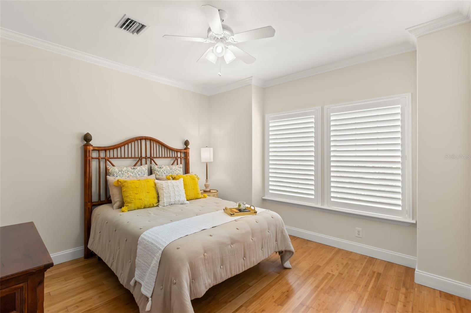 Bright and airy guest bedroom with ample natural light, offering a welcoming space for rest and relaxation.