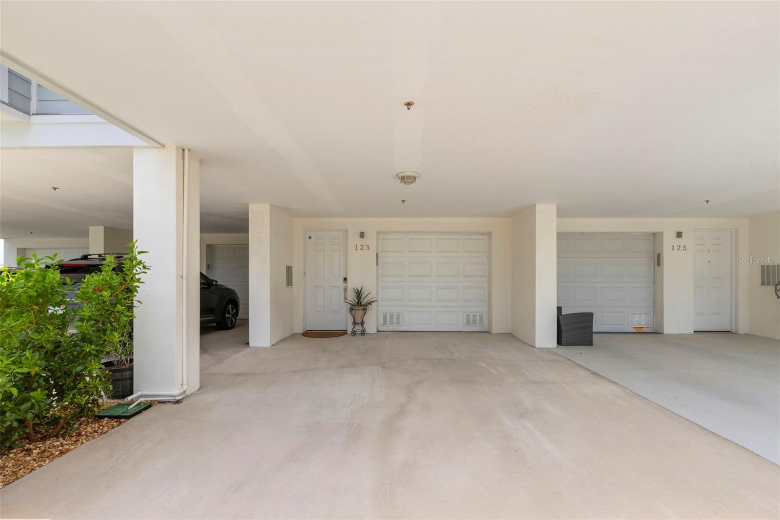 Spacious and covered parking area providing convenient access to your private garage and entryway, ensuring security and ease for your vehicles.