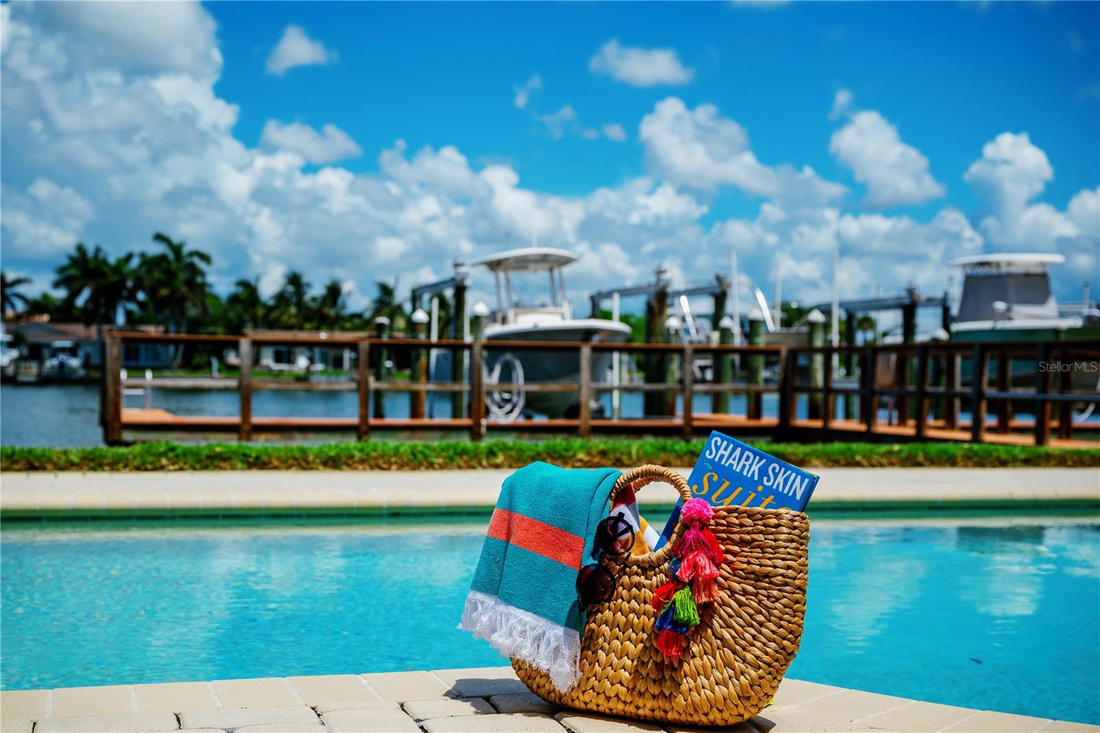 A beach day is calling! This stylish tote is packed and ready with sunglasses, a good summer read, and a colorful towel for those perfect poolside or sandy moments.