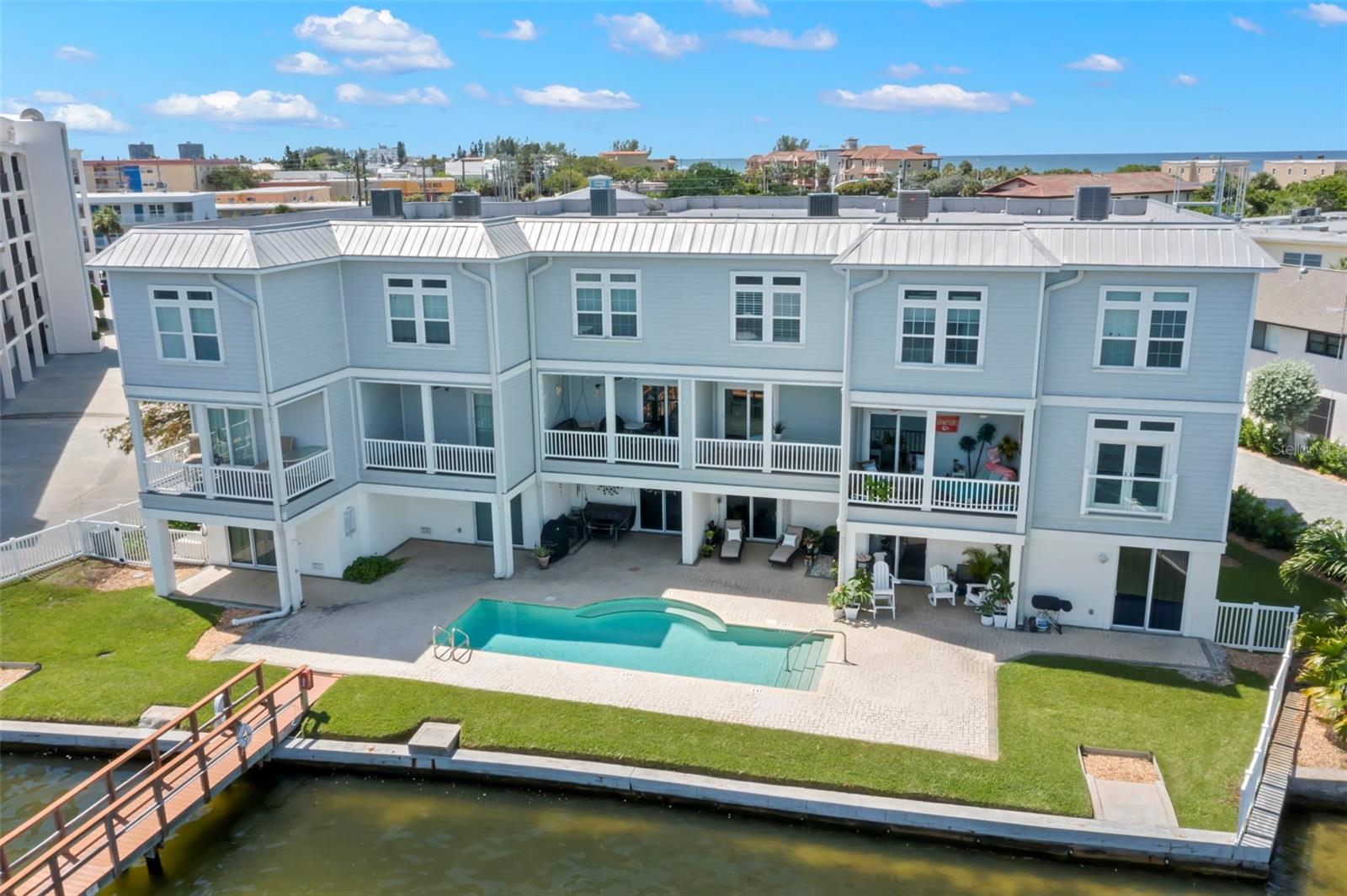 Overlooking the water, this stunning townhouse features spacious balconies and a refreshing pool, providing the perfect setting for relaxing and entertaining.