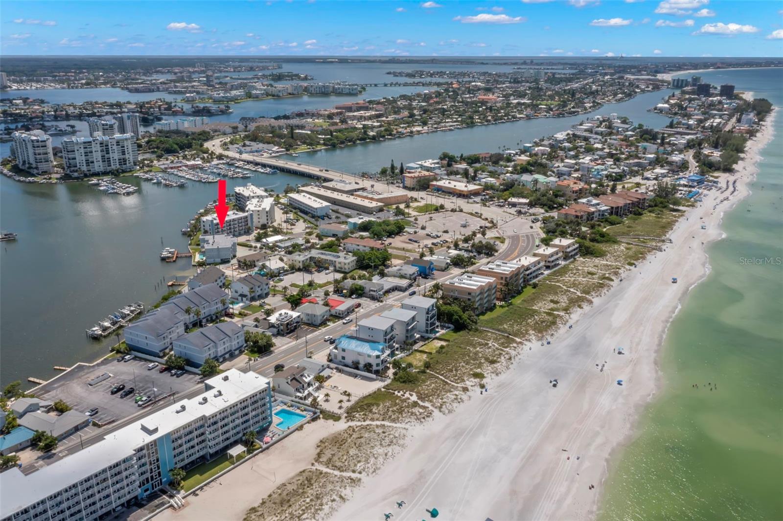 Aerial view highlighting the prime waterfront location of the townhome with quick access to the beach.