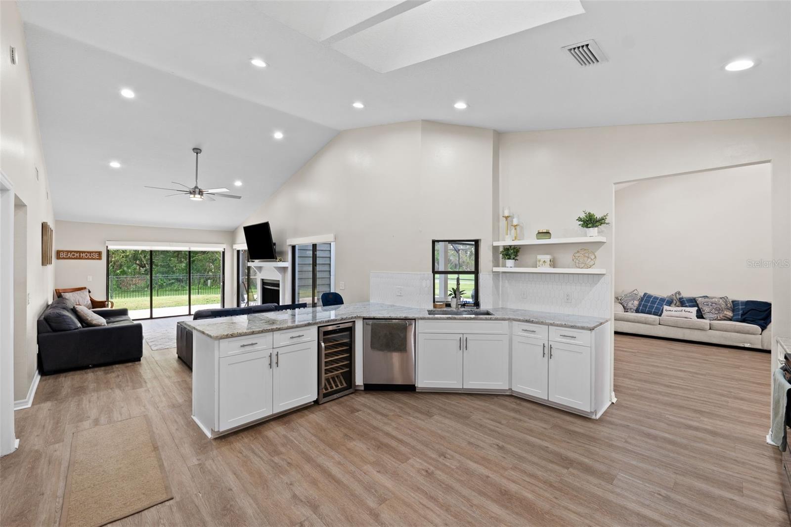 Kitchen overlooking living room with fireplace