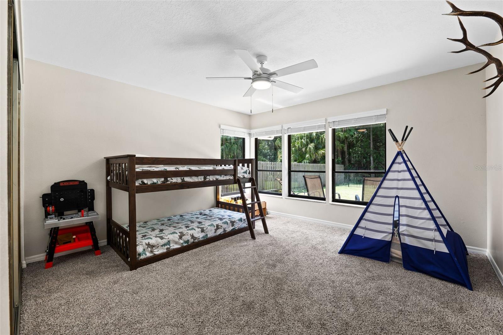 Very Large Second Bedroom with windows overlooking fenced in backyard.