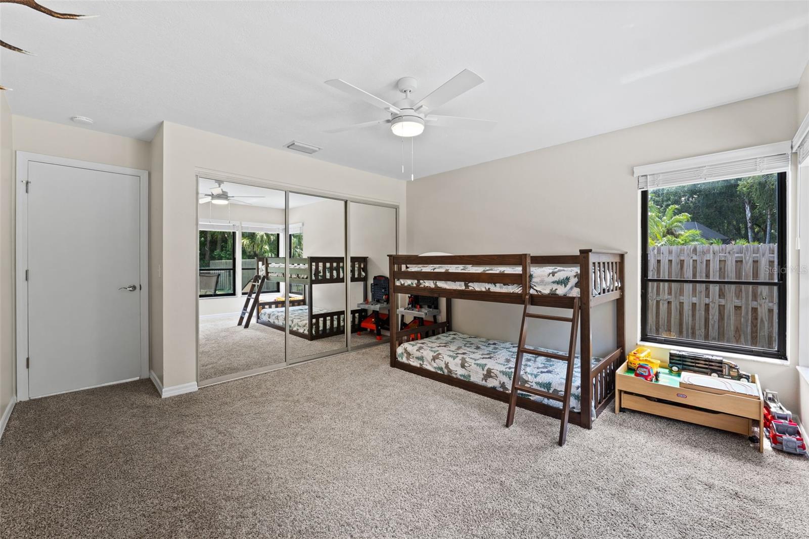 Very Large Second Bedroom with windows overlooking fenced in backyard.