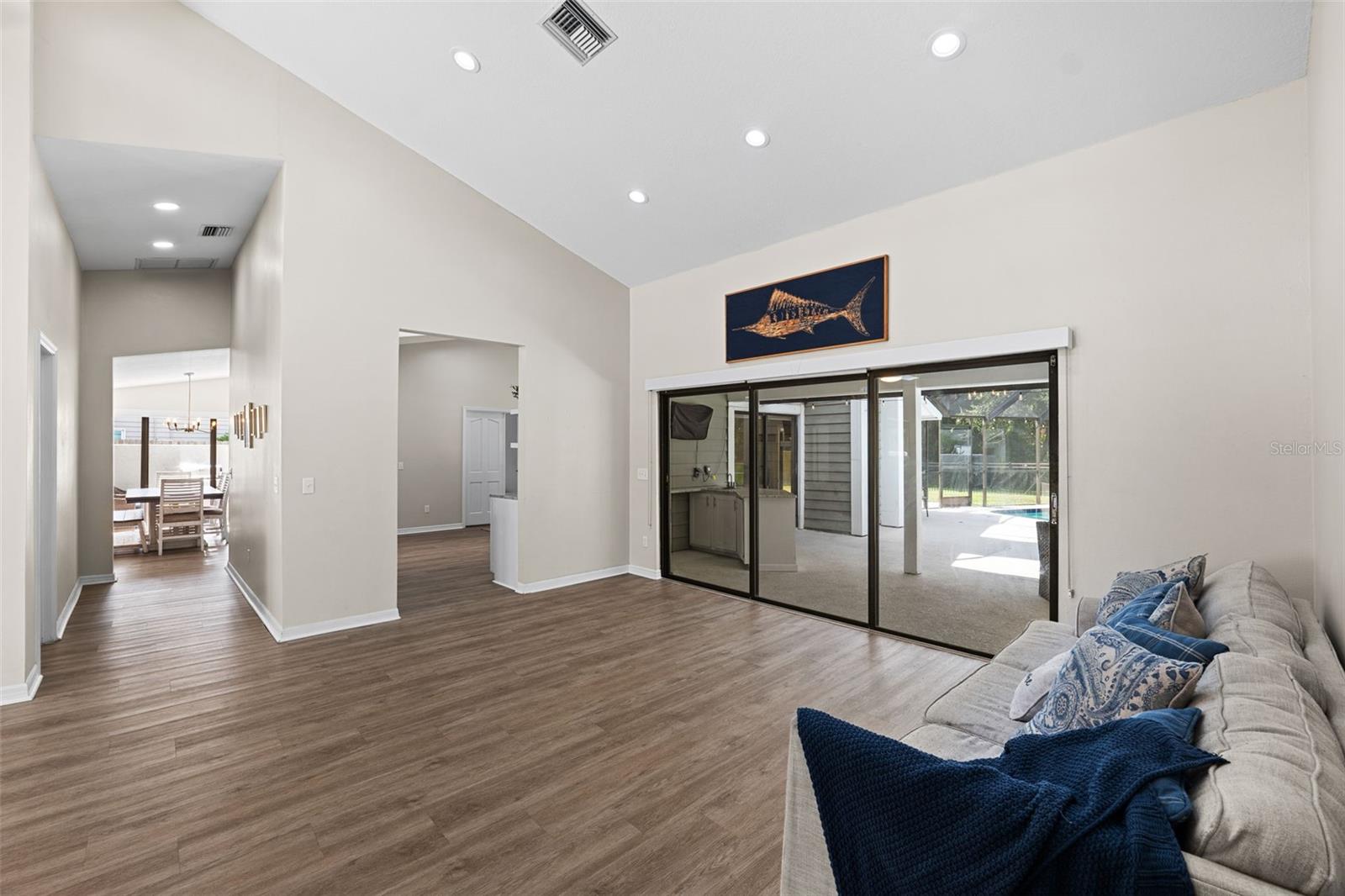 Family room with hallway to dining room, fourth bedroom, laundry room and garage.