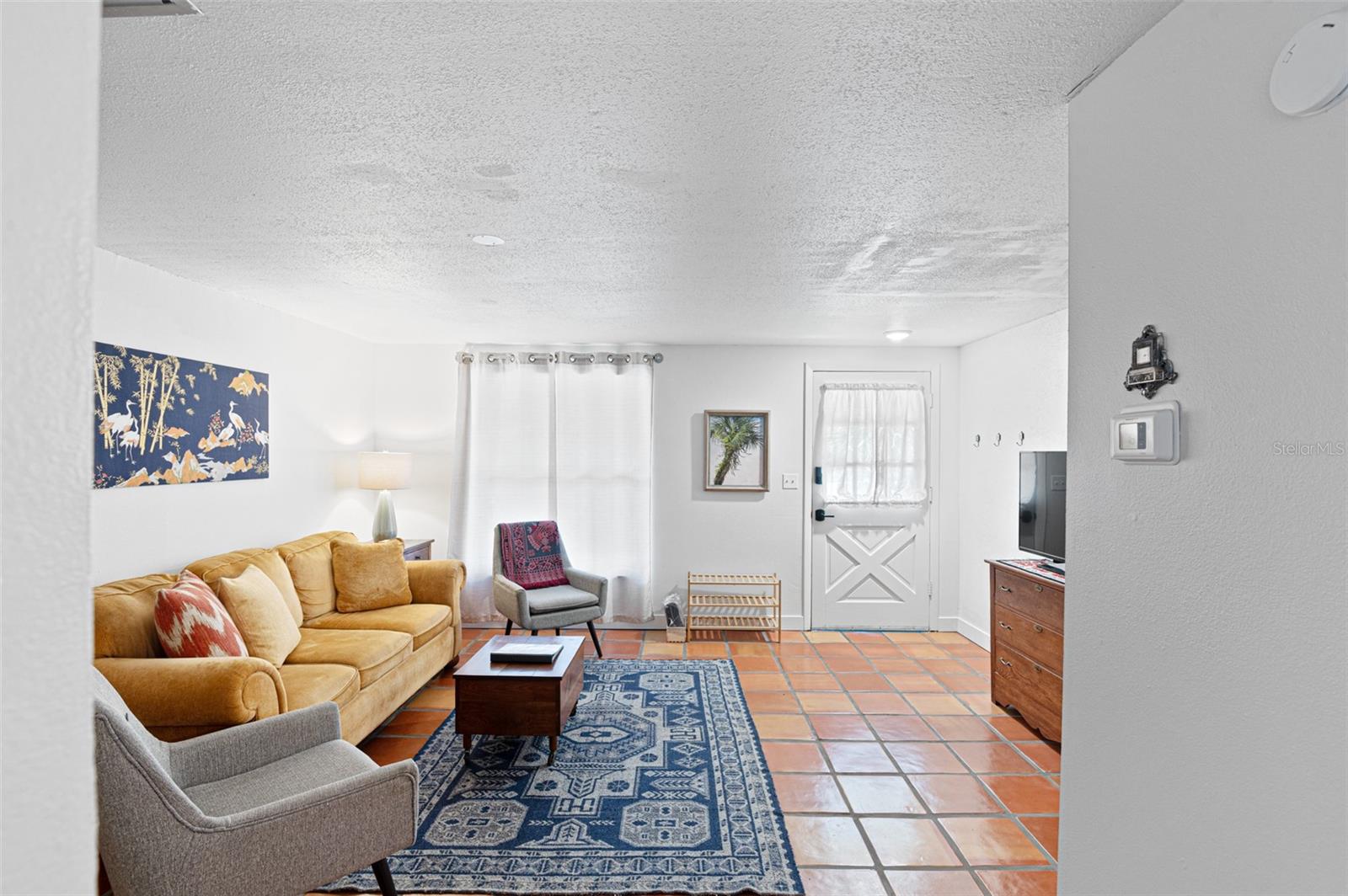 View from the kitchen of the living room and front entry door.