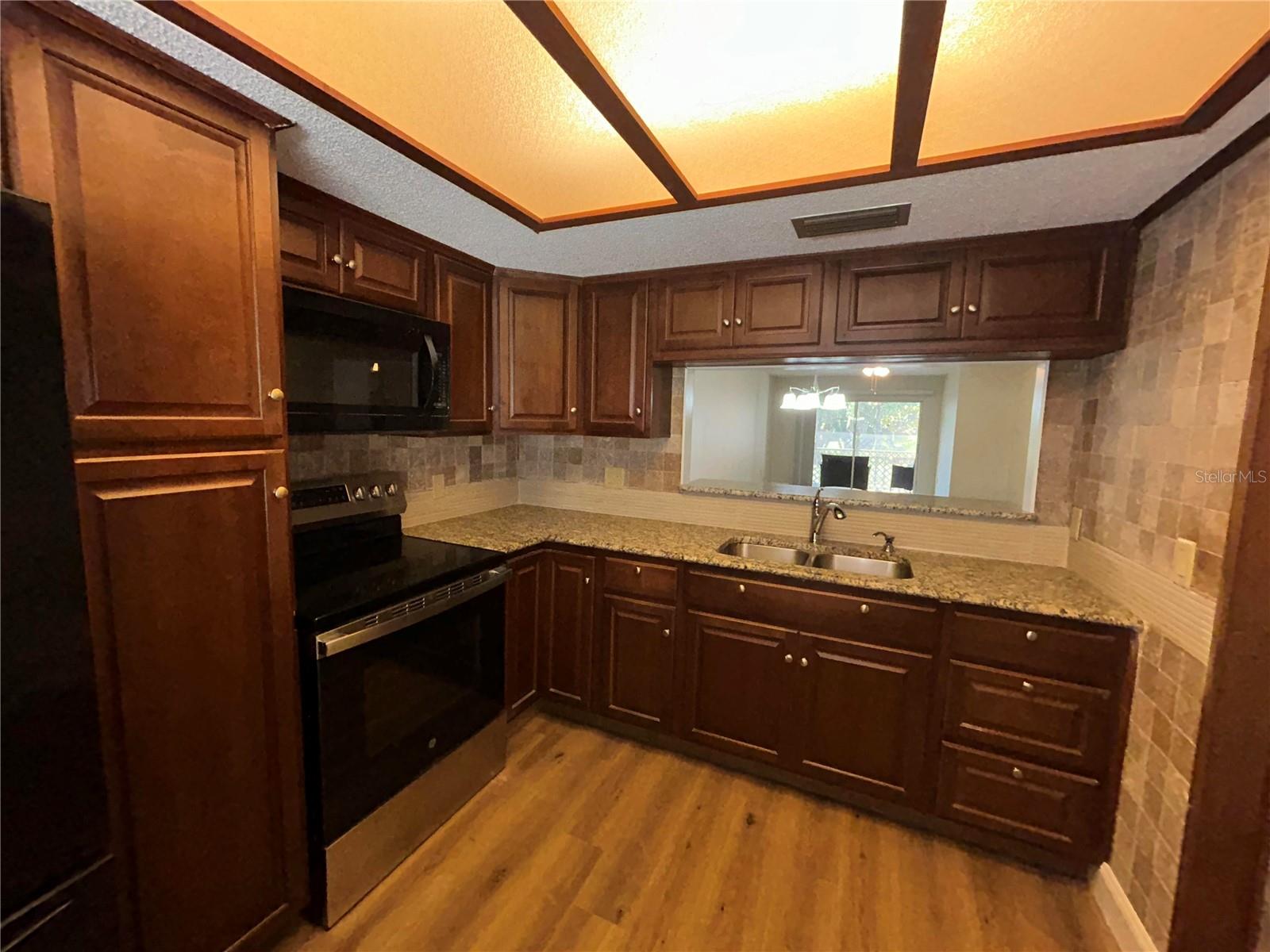 Kitchen with granite countertops, solid wood cabinets and views