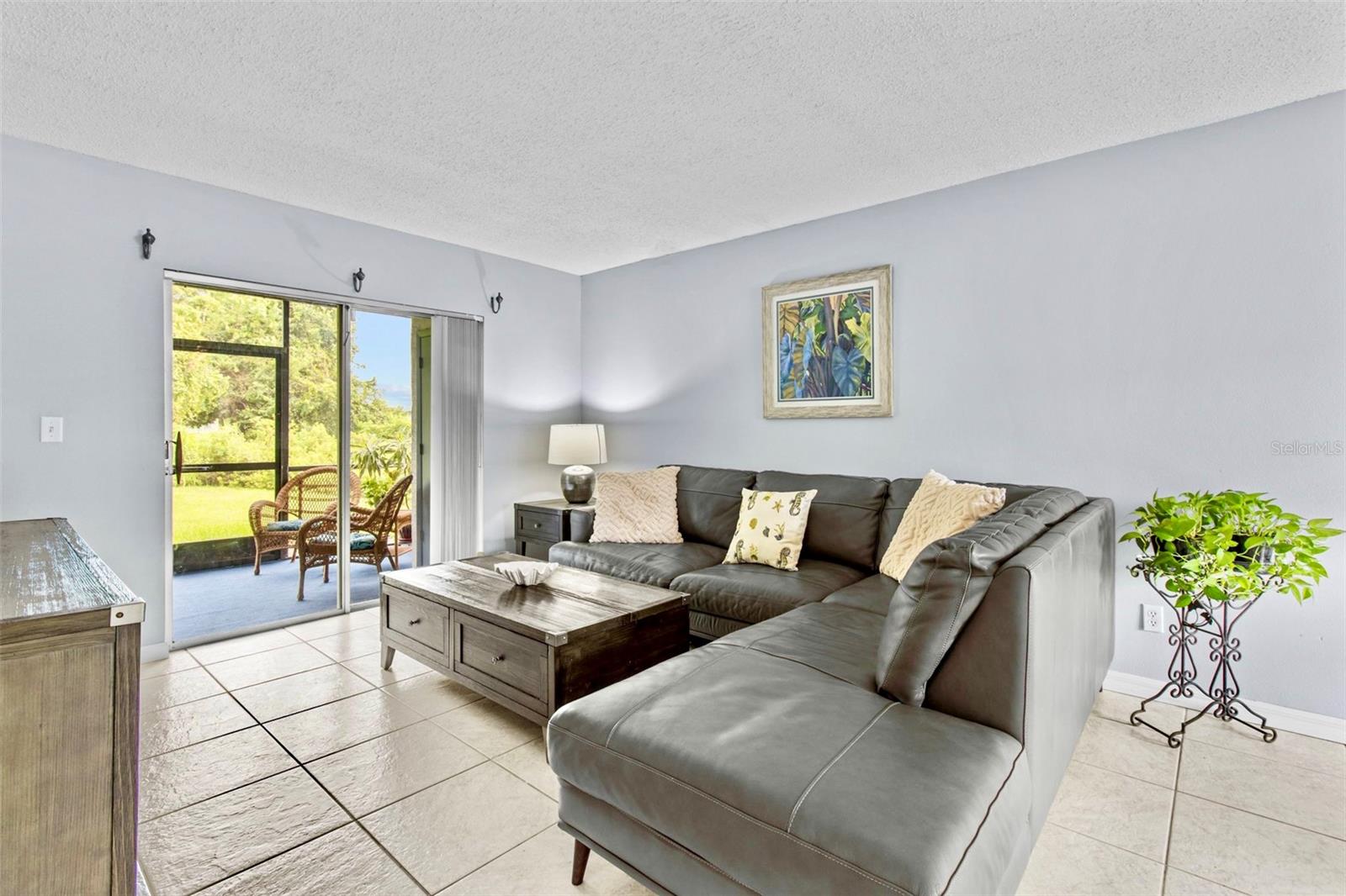 Living area with sliders to screened porch / terrace / lanai / patio.