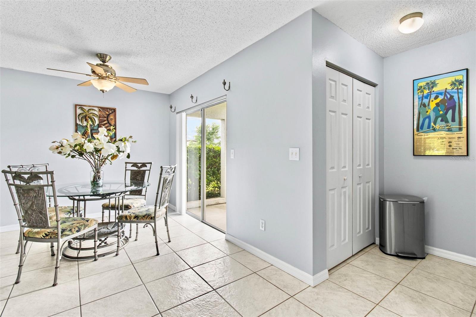 Dining area with linen closet & sliders to front patio.