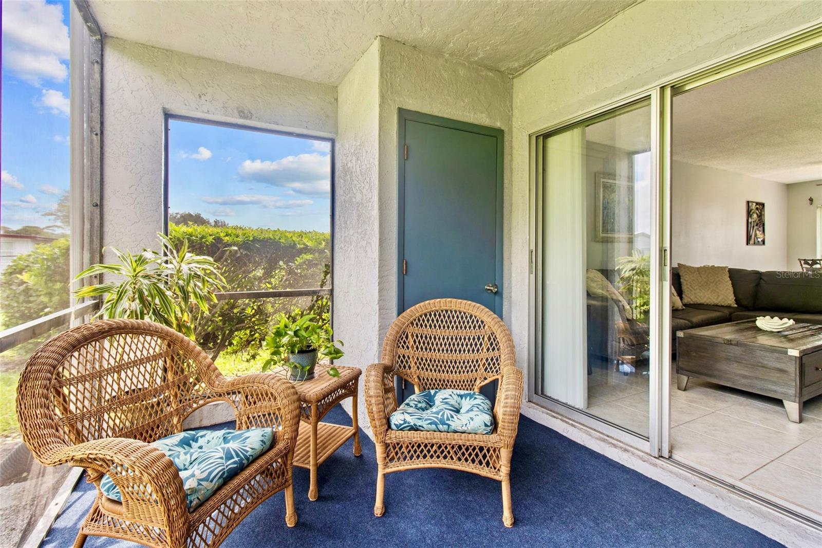 Screened lanai offers lovely private views and a storage closet.