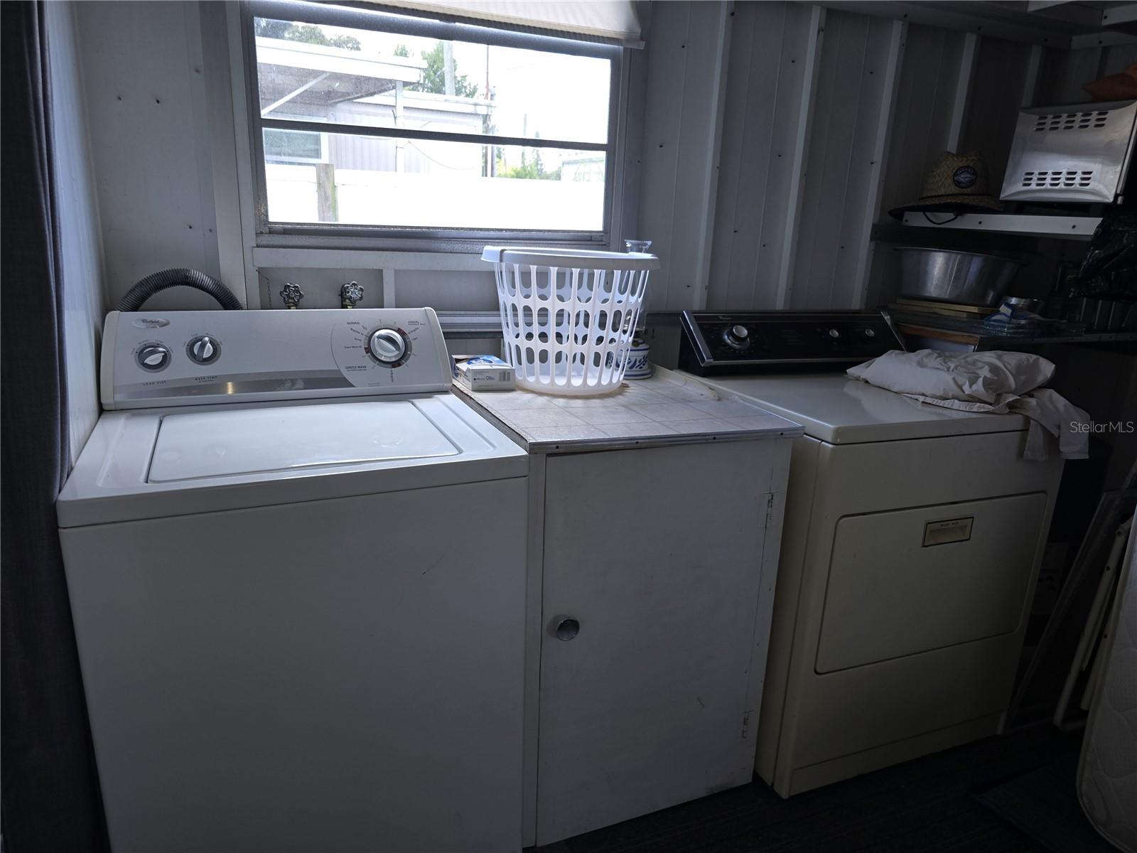 Large separate Laundry room with 1/2 bath and lots of storage