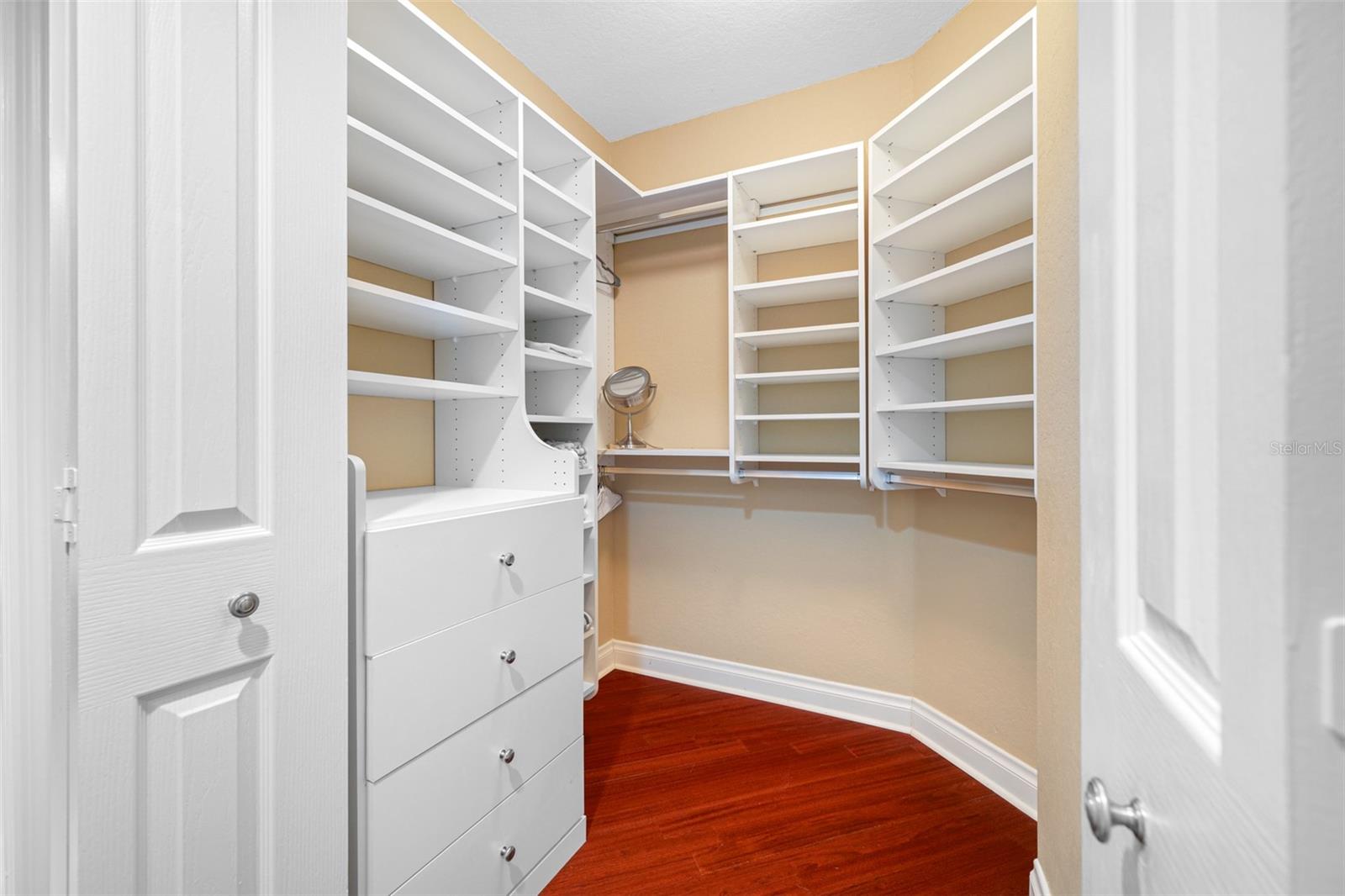 Walk in closet with custom organizer system and additional built in closet as well!