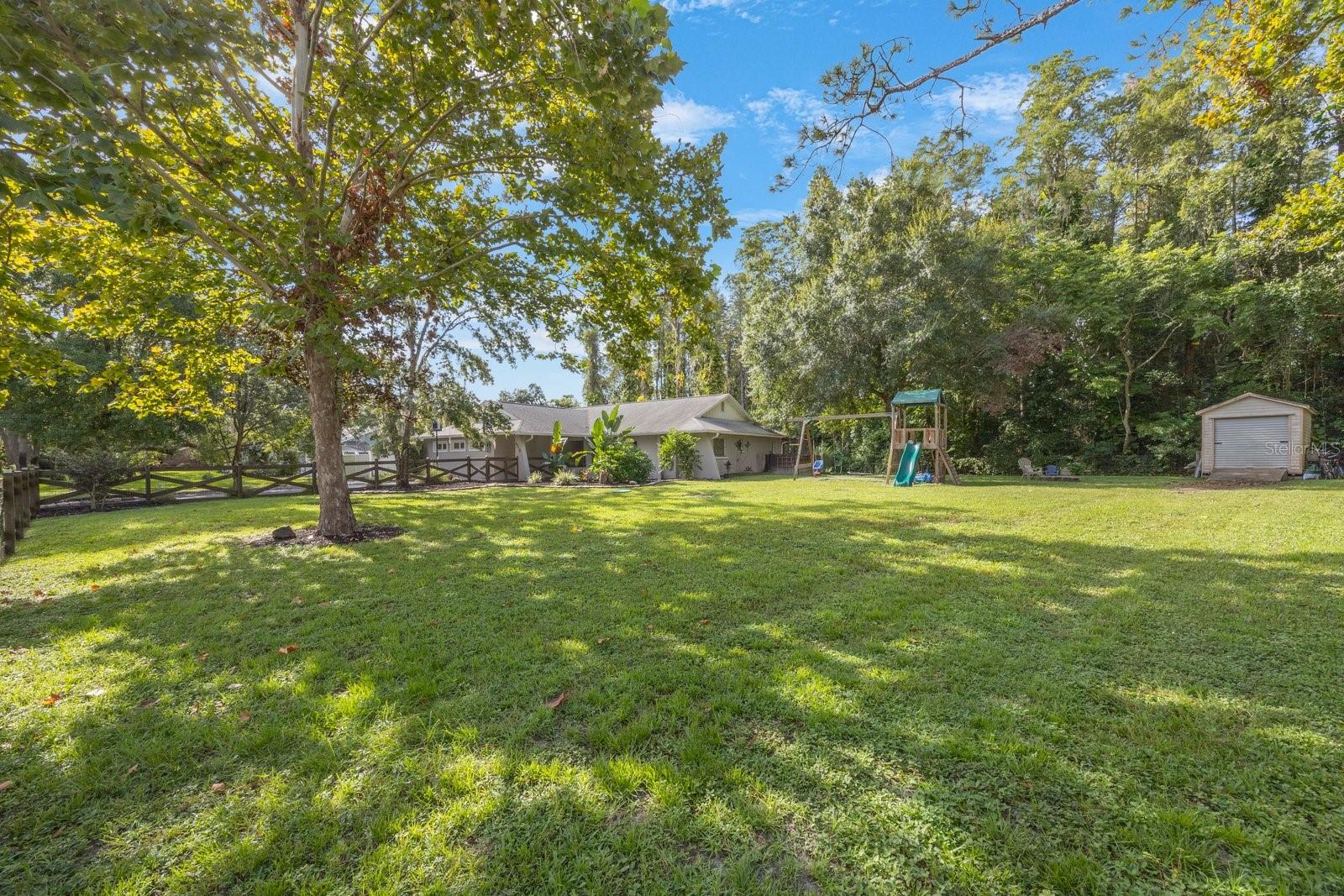 HOUSE SHOWING STORAGE SHED AND PLAYSET