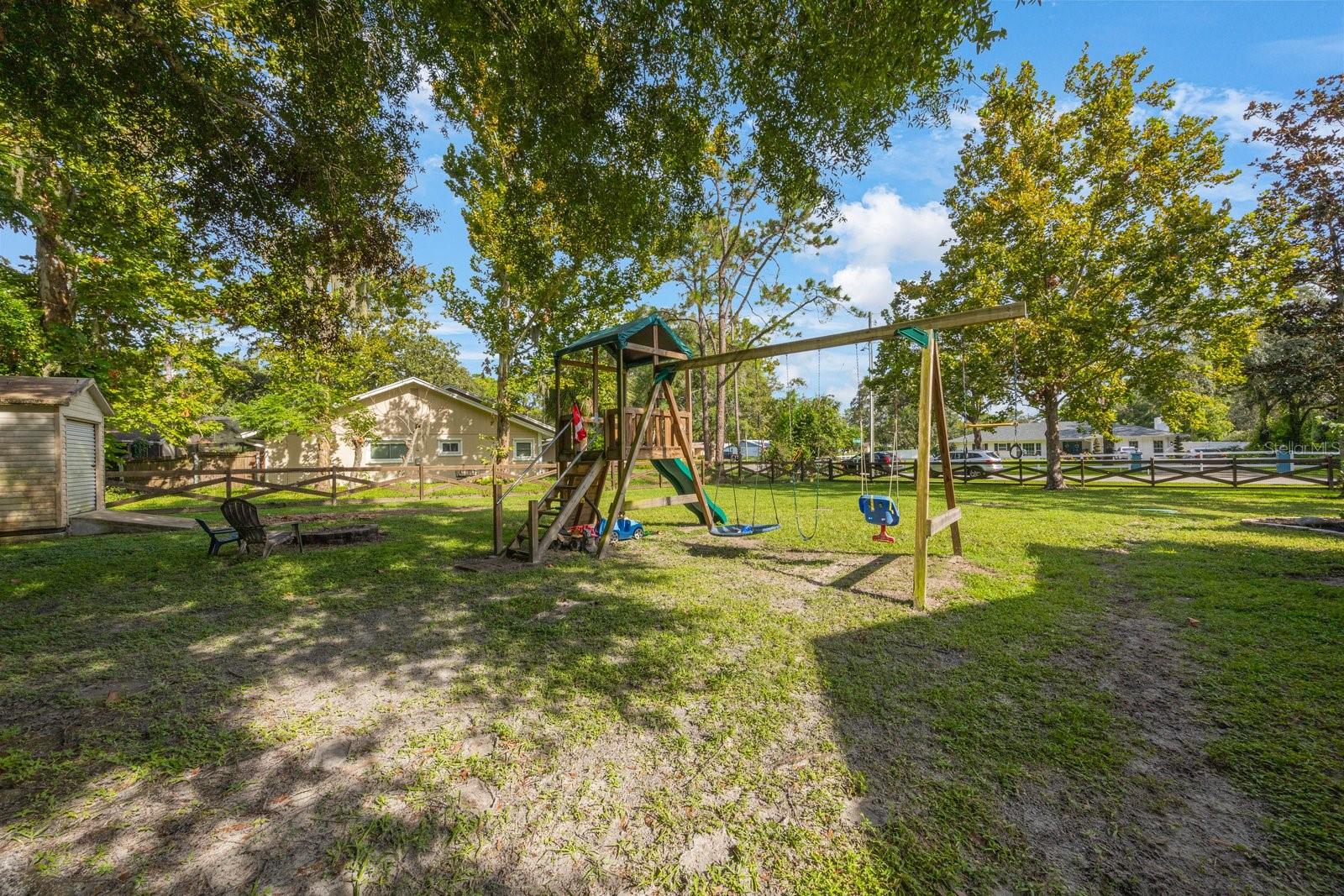 SIDE OF YARD SHOWING FENCING, SHED AND PLAYSET