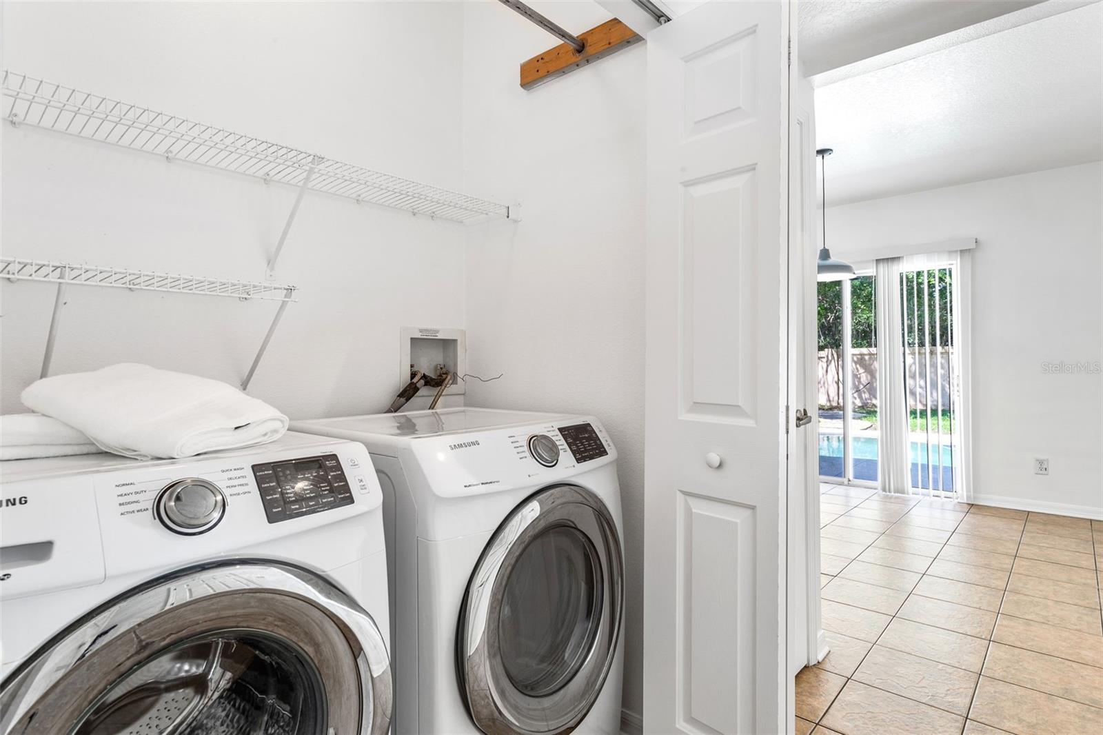 Laundry closet with shelving.