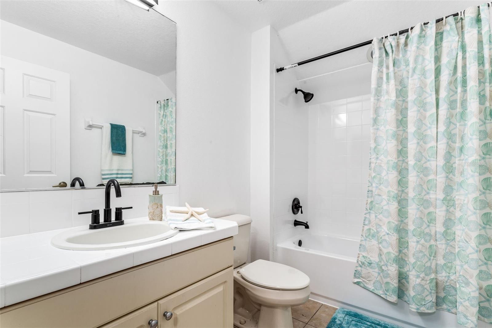 Another full shared bathroom. Tub/shower combo newly glazed, glazed counter, new sink, faucets and light fixture.