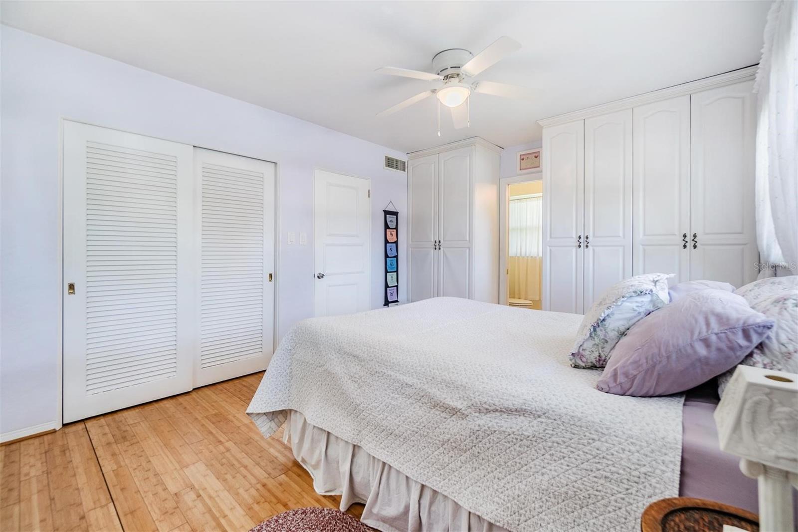 Primary bedroom at the front of the home with two large windows, a wall closet, two wardrobes and ensuite bathroom