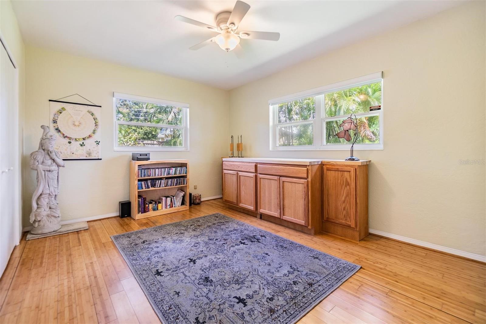 Second bedroom with garden view windows, three closets, and extra sleep space with a built-in murphy bed when needed.