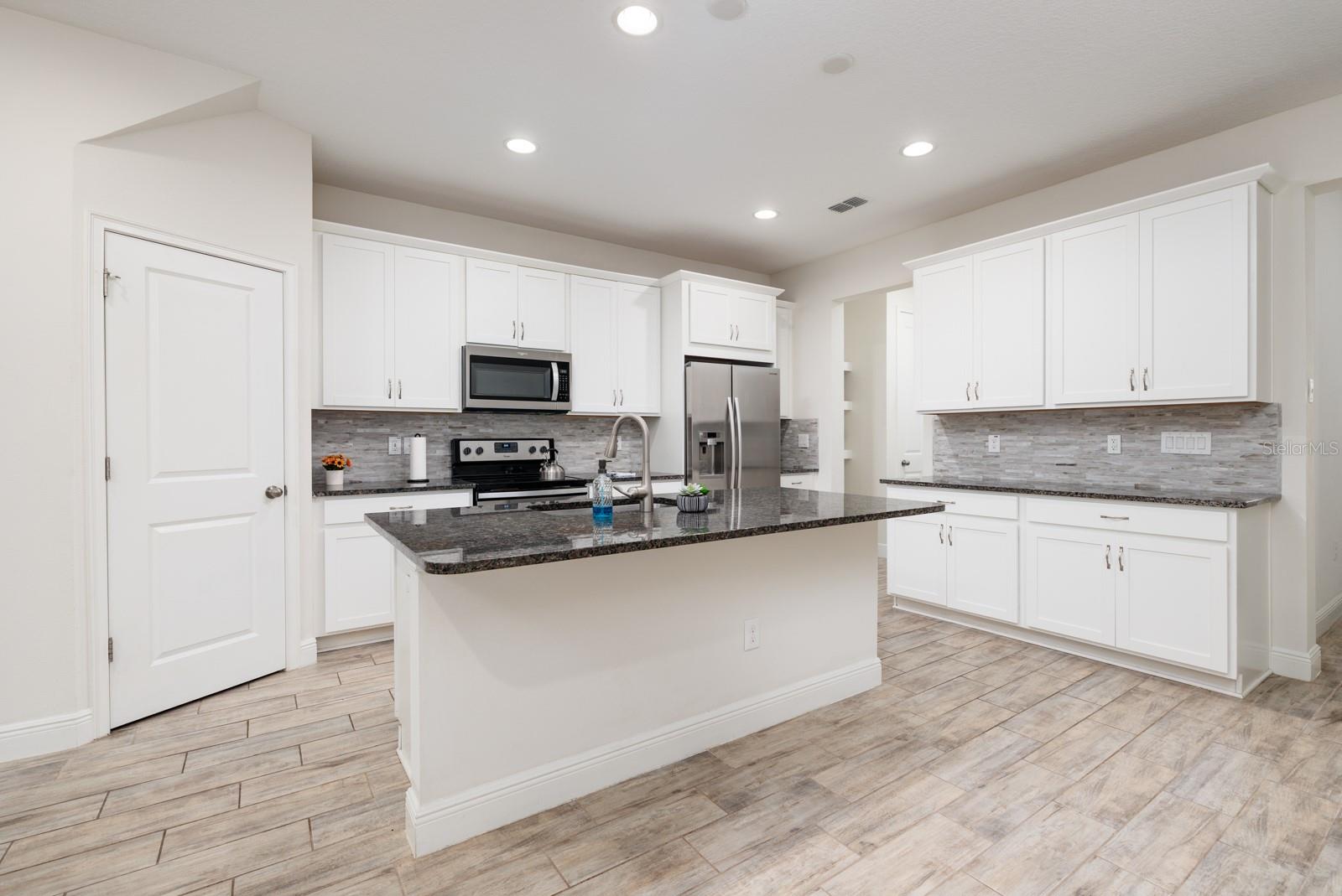 Kitchen with loads of granite counter tops