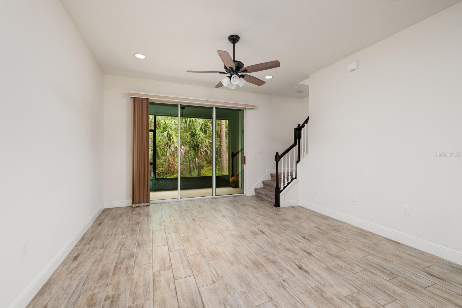 Living Room - view toward preserve beyond enclosed porch.