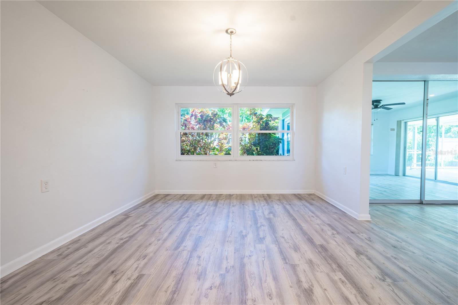 The dining room is highlighted by a trendy pendant light, perfectly positioned above the dining table.