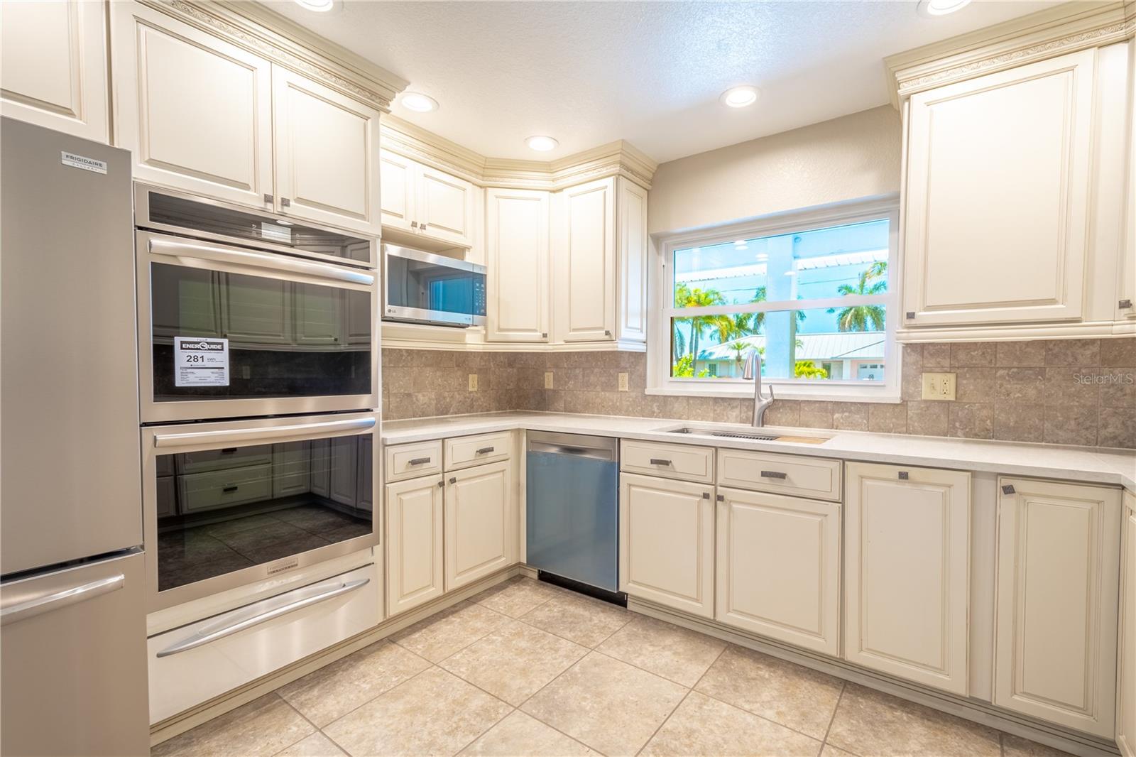 The completely updated, modern kitchen boasts sleek quartz countertops, state-of-the-art stainless steel appliances, and custom cabinetry for a perfect blend of style and functionality.