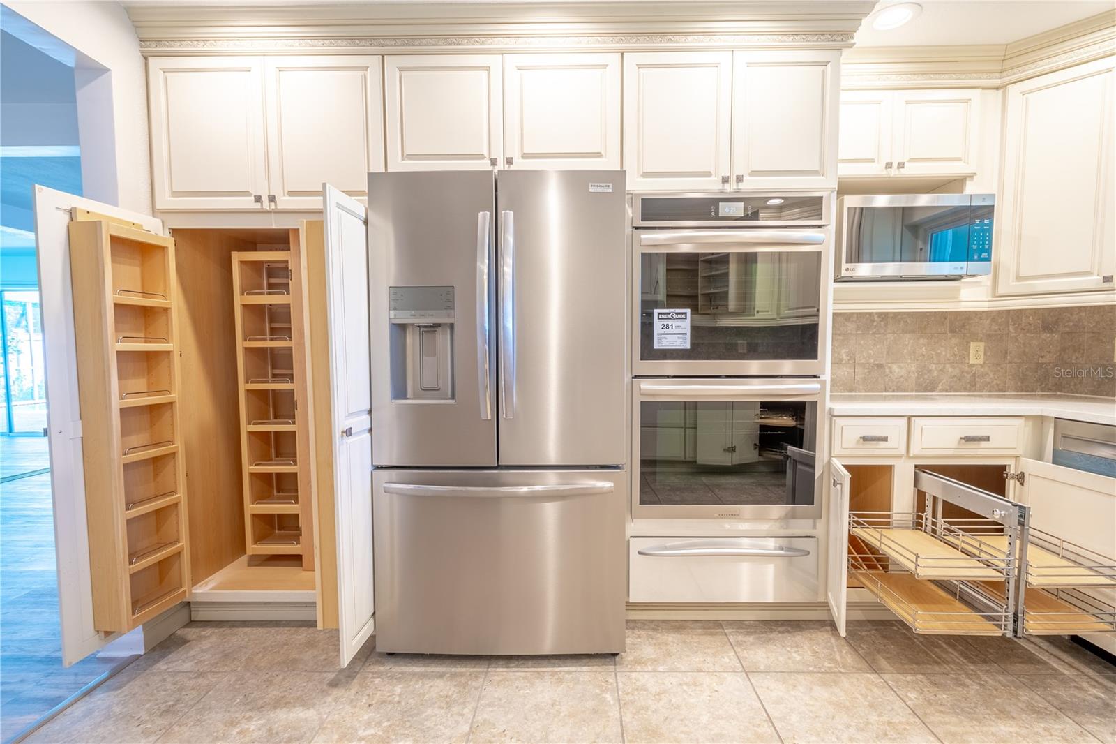 The kitchen features upgraded cabinetry and custom drawers and cabinets. The large custom pantry is a cook's delight.