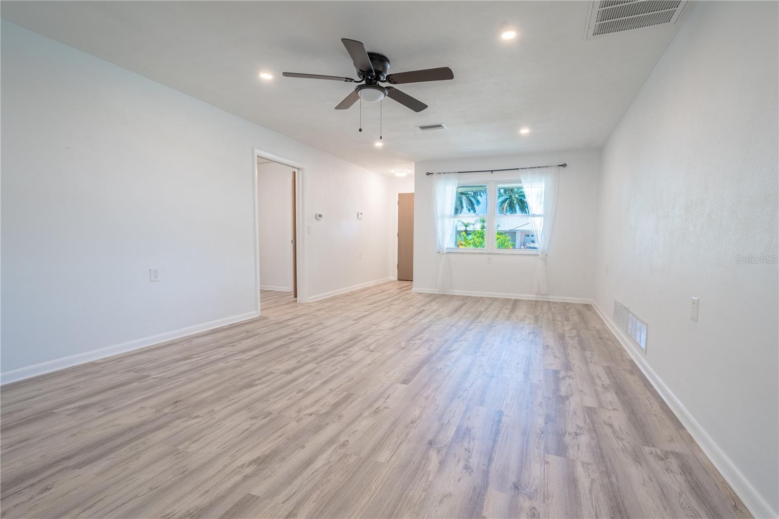 The living room has a ceiling fan with light kit.