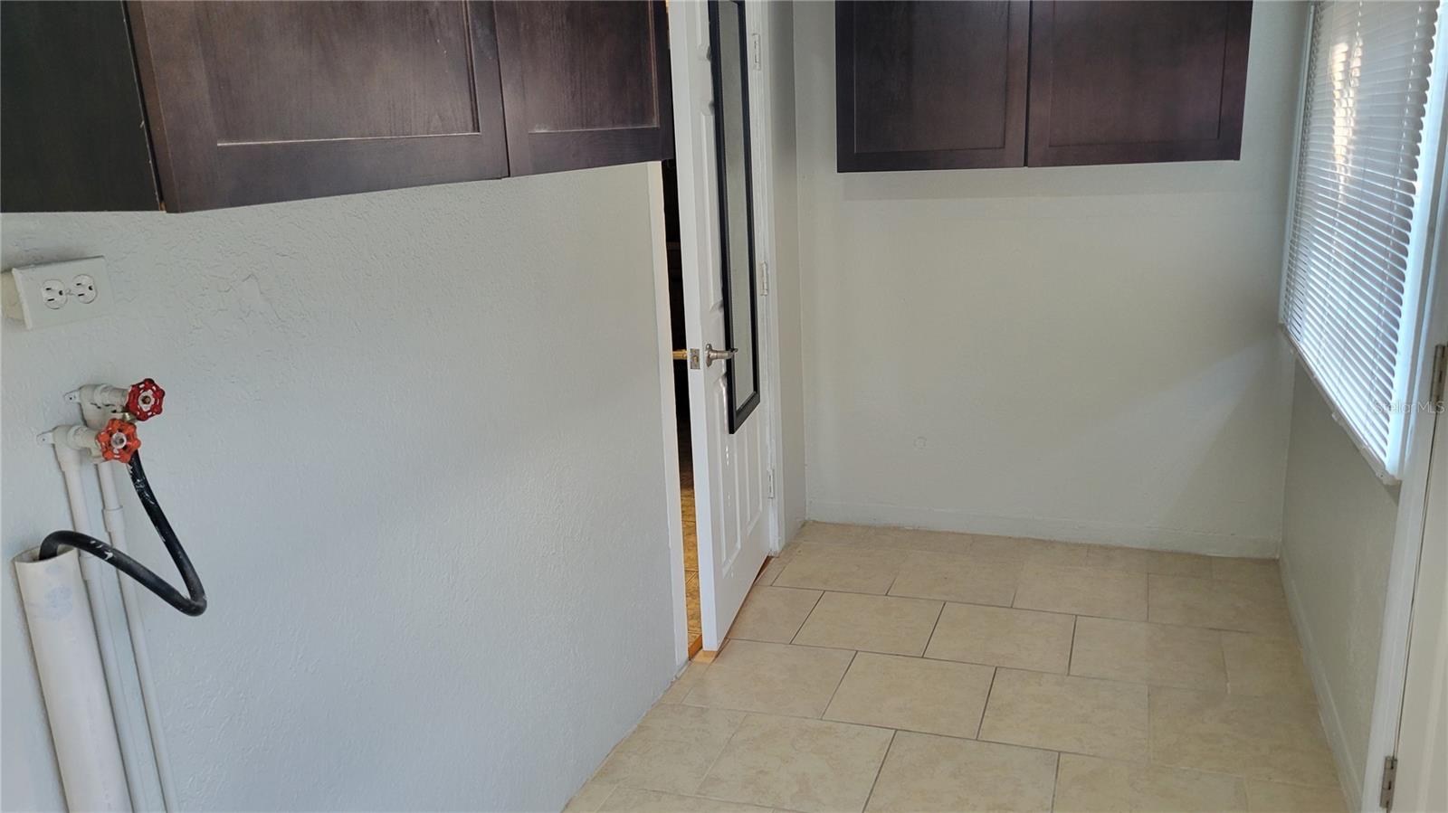 Byron inside utility room w/ full washer and dryer hook-ups