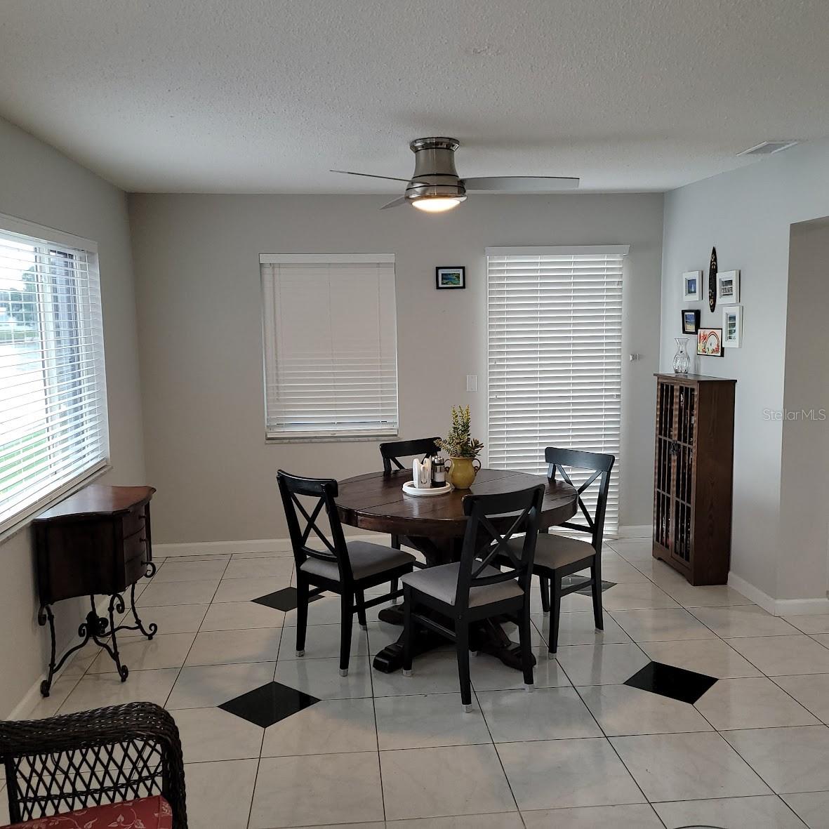 The dining area offers the nice view of the water outside and quick access to the kitchen.