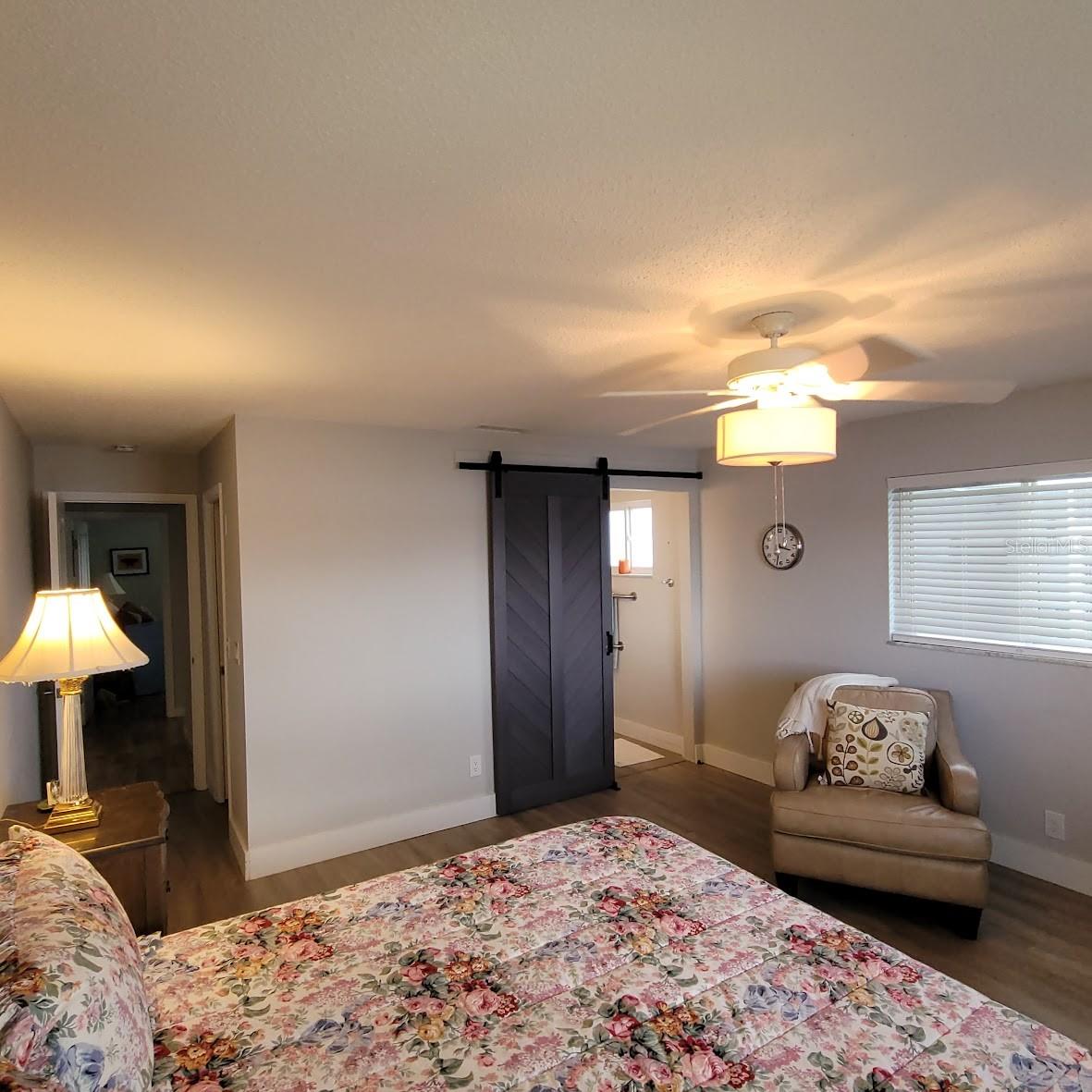 Another view of the Primary Bedroom. This king sized bed and side tables fit with room left for dressers and a chair.