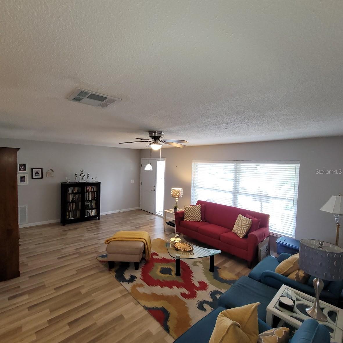 This living room view shows the front door entry and window.