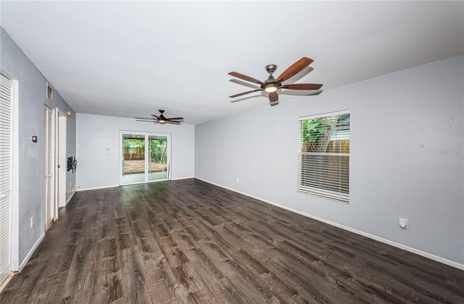 Dining and living spaces with views into the screened patio and side yard