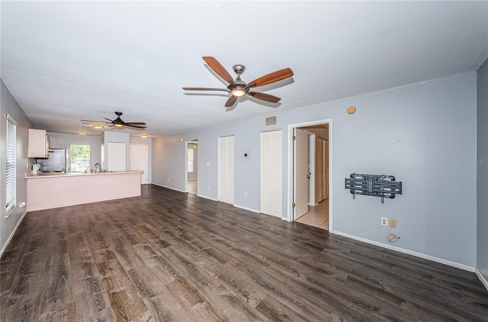 From the sliding glass doors, a view of the living, dining and kitchen spaces