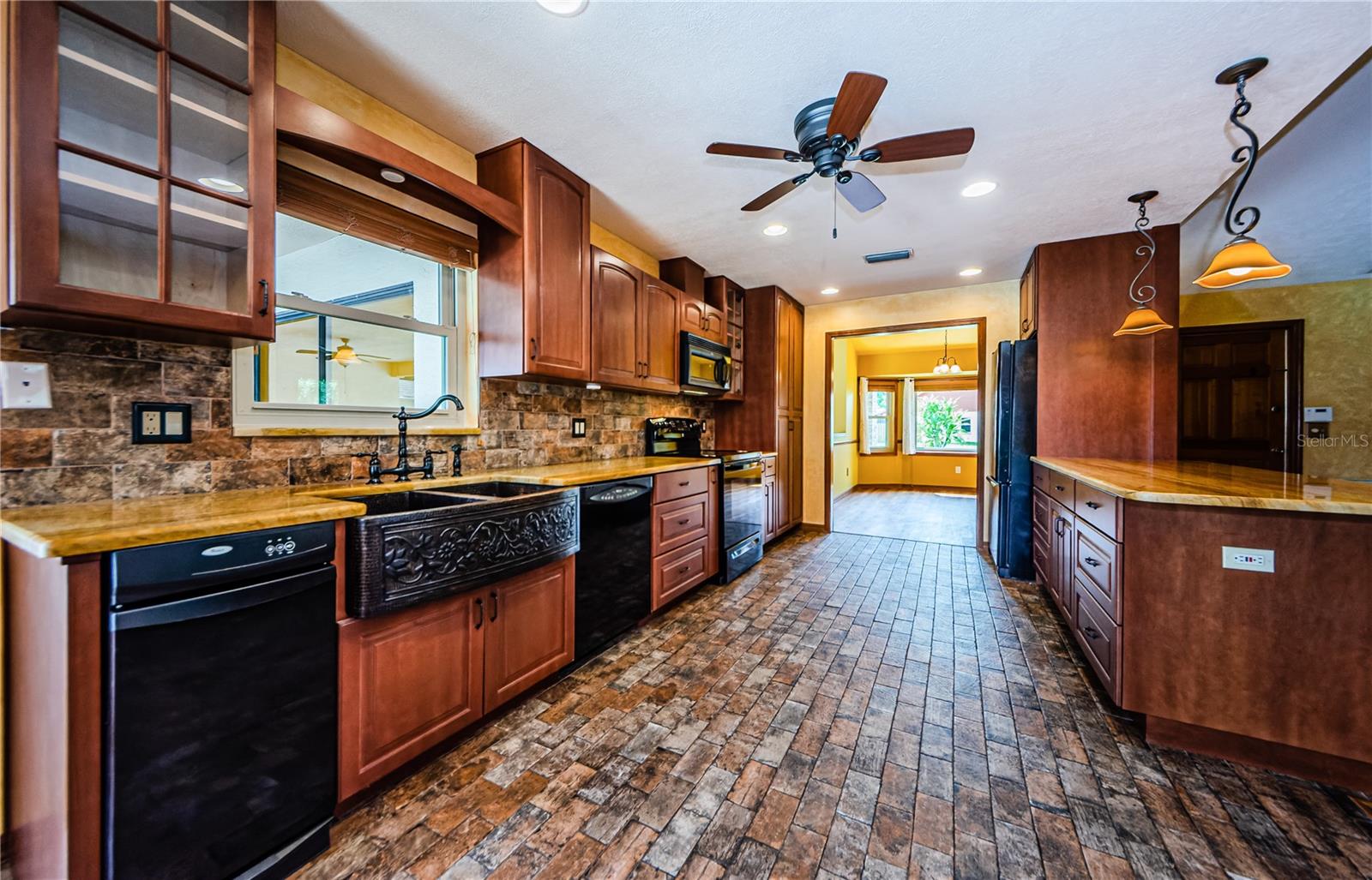 Tuscan kitchen with porcelain tile, copper sink, quartzite countertops