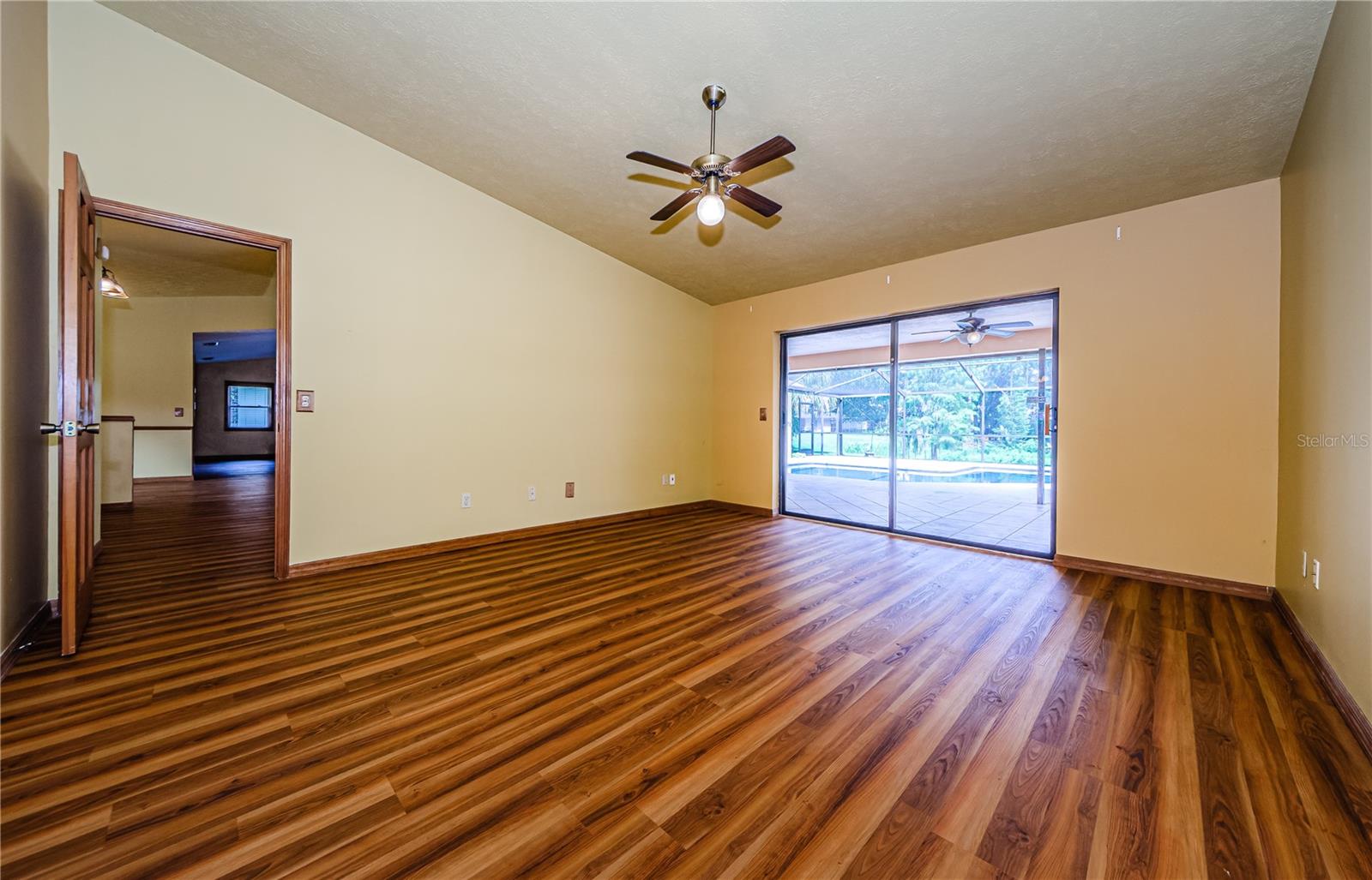 Primary bedroom with sliders to the pool