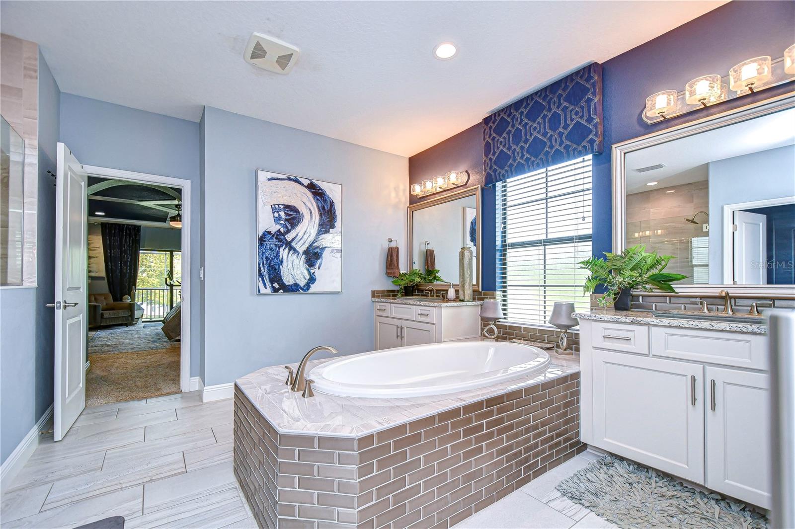 Stand alone soaking tub with His and Hers vanities!