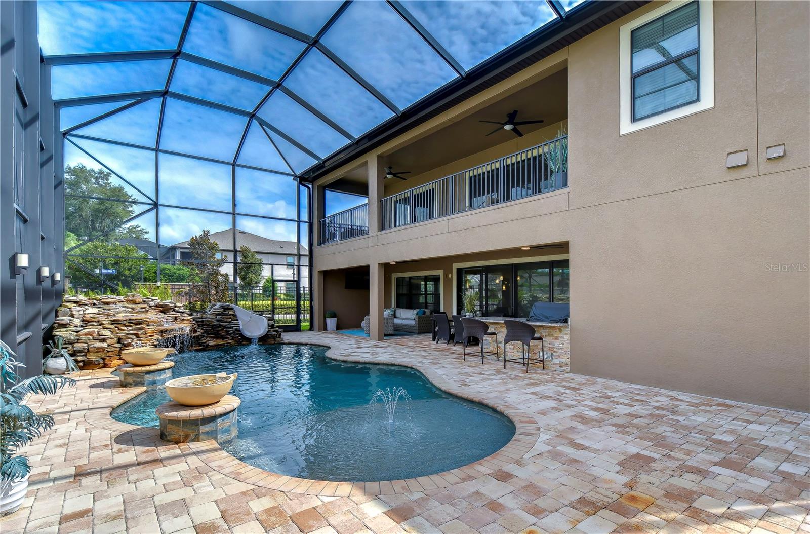 This oversized pool has a sun shelf and pavered patio!