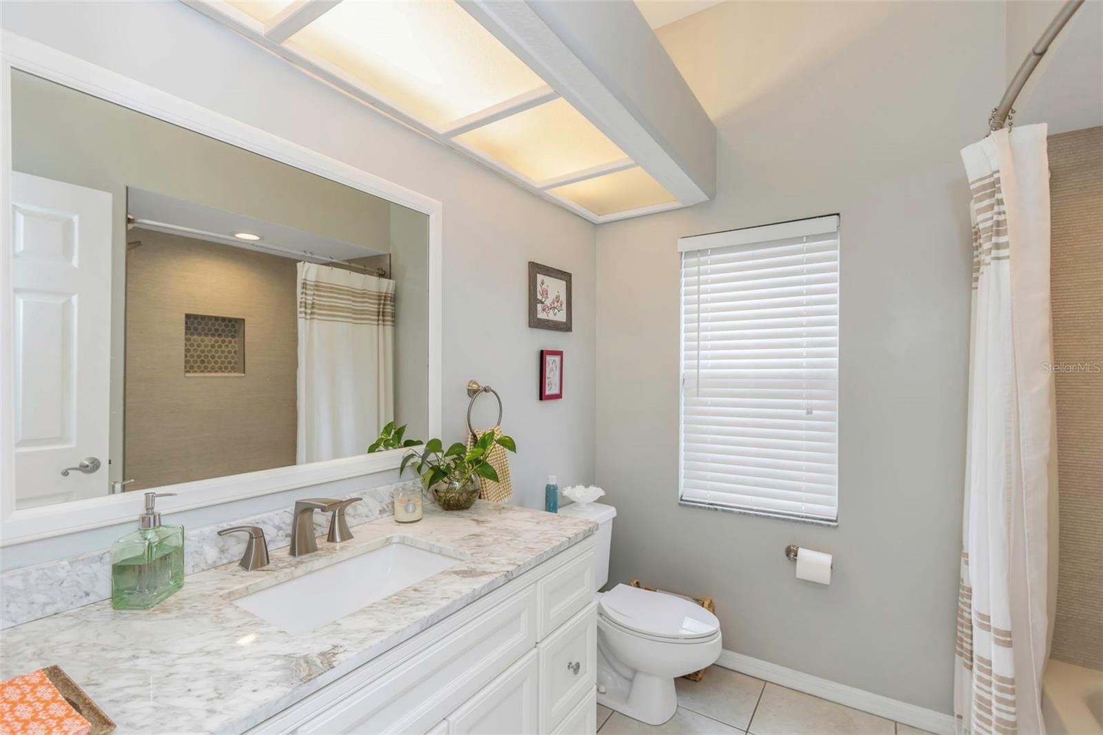 Guest bath with tub / shower combination located between bedrooms 2 & 3.