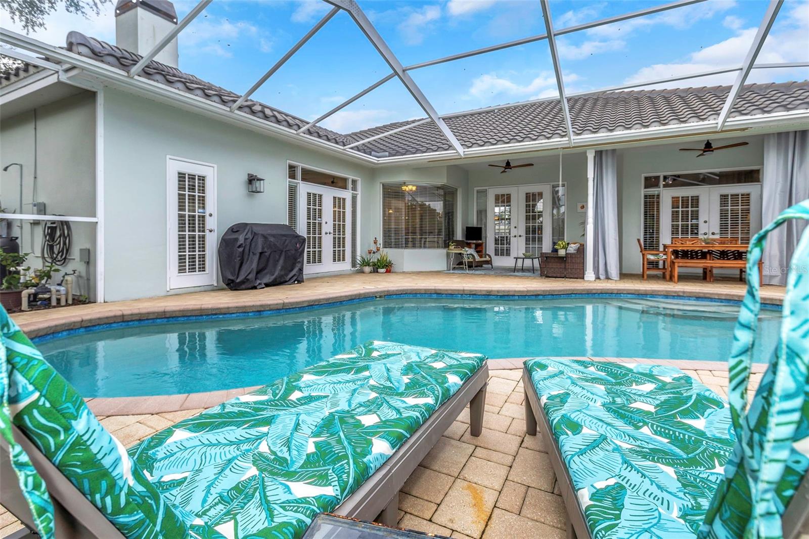 Relax pool side in your screen enclosed patio.